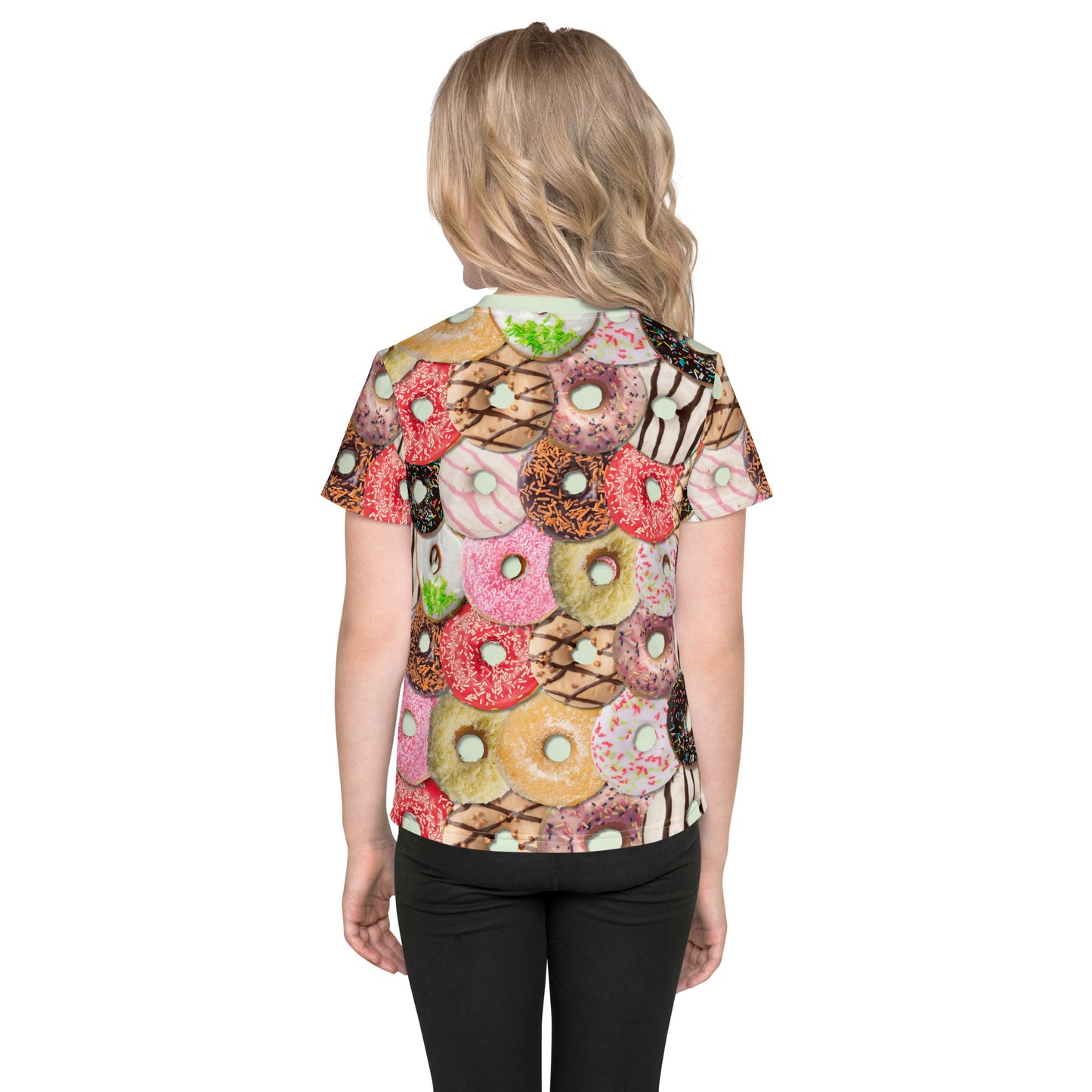 Little girl wearing a colourful iced doughnuts all over print T-shirt, back.