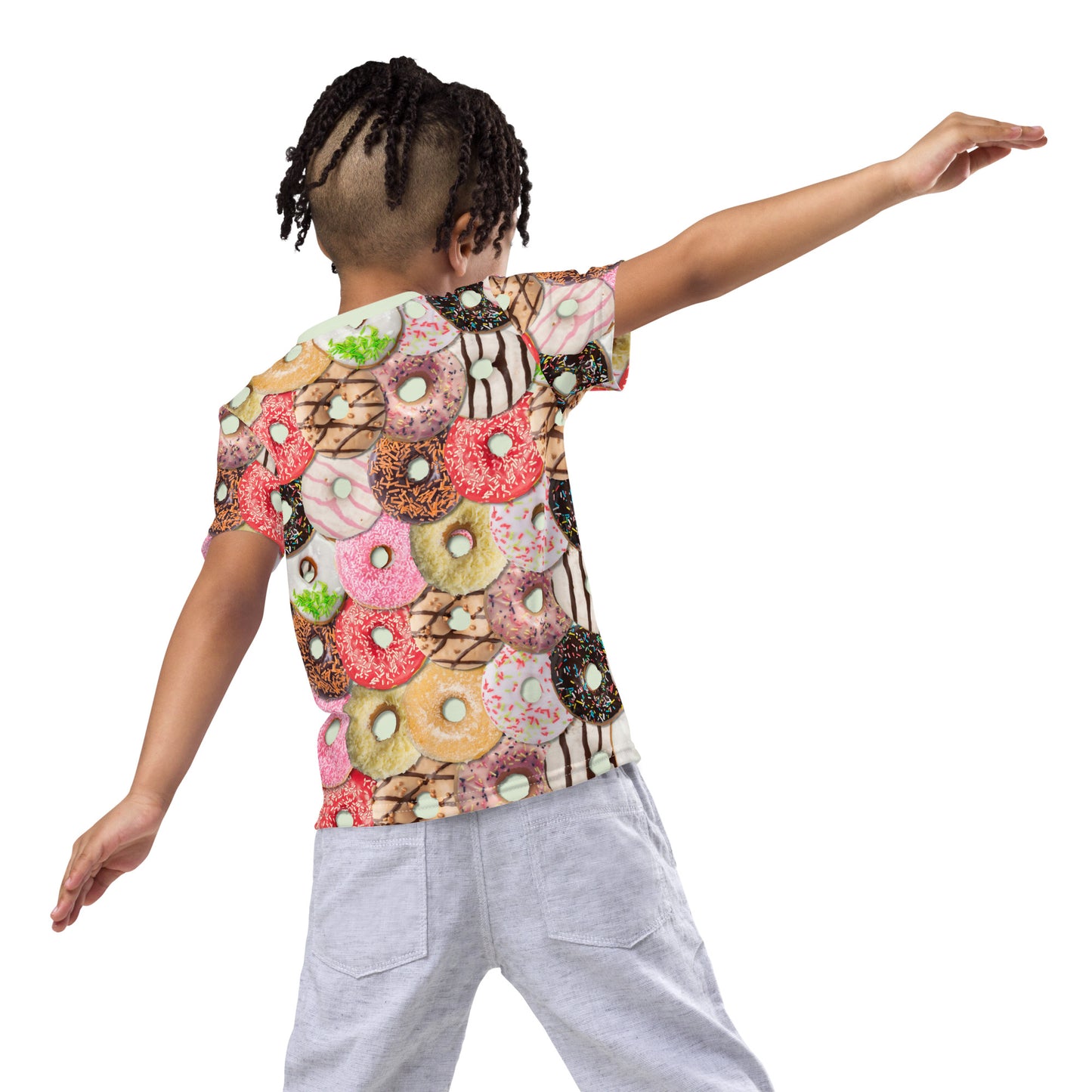Little boy wearing a colourful iced doughnuts all over print T-shirt, rear view.