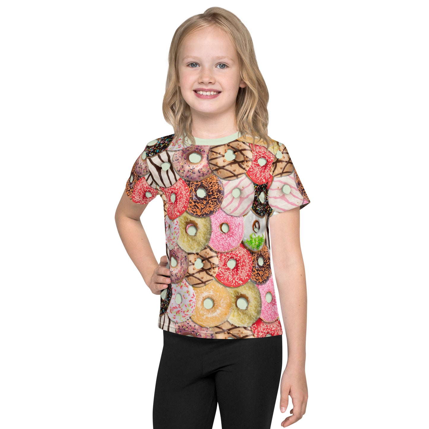Little girl wearing a colourful iced doughnuts all over print T-shirt, front view.