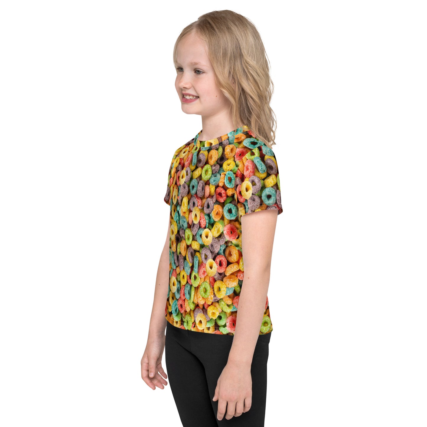 Little girl wearing an all over print Fruit Cereal Loops T-shirt, left side view