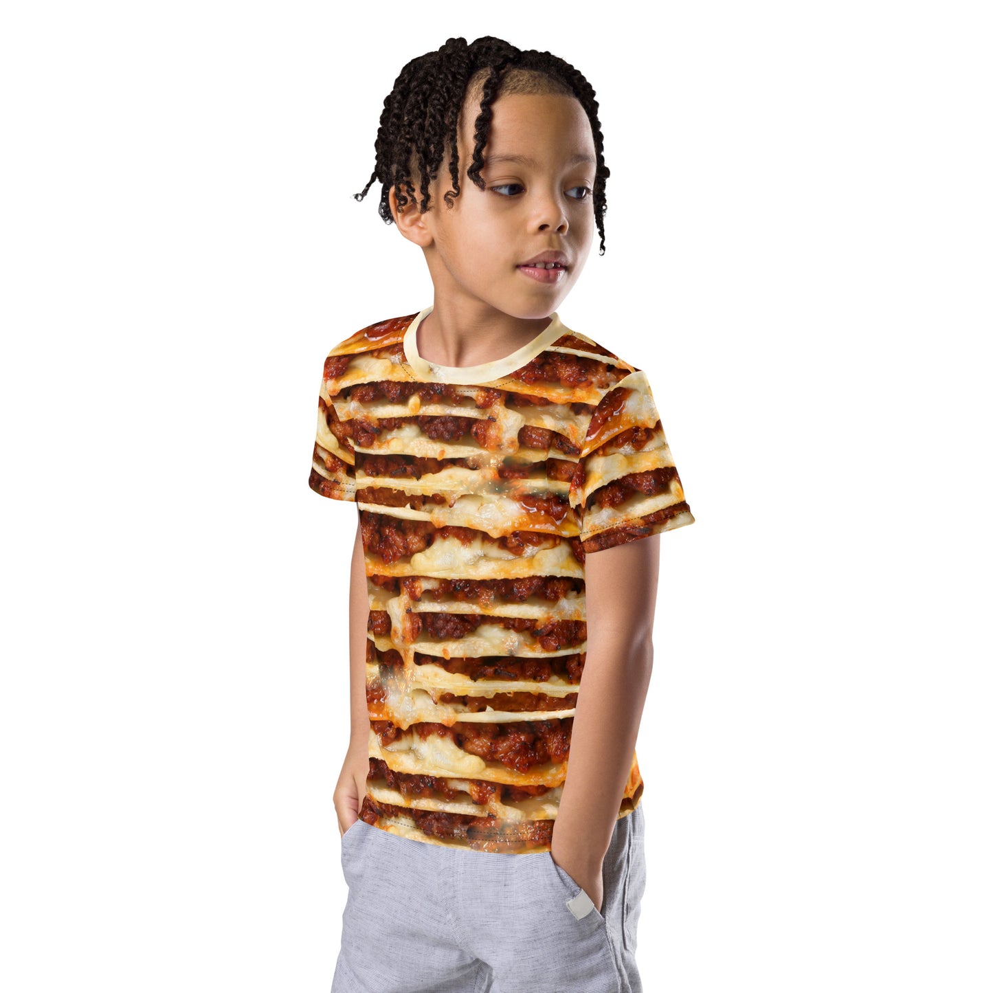 Little boy wearing an all over print lasagne layers kid's T-shirt. front left view