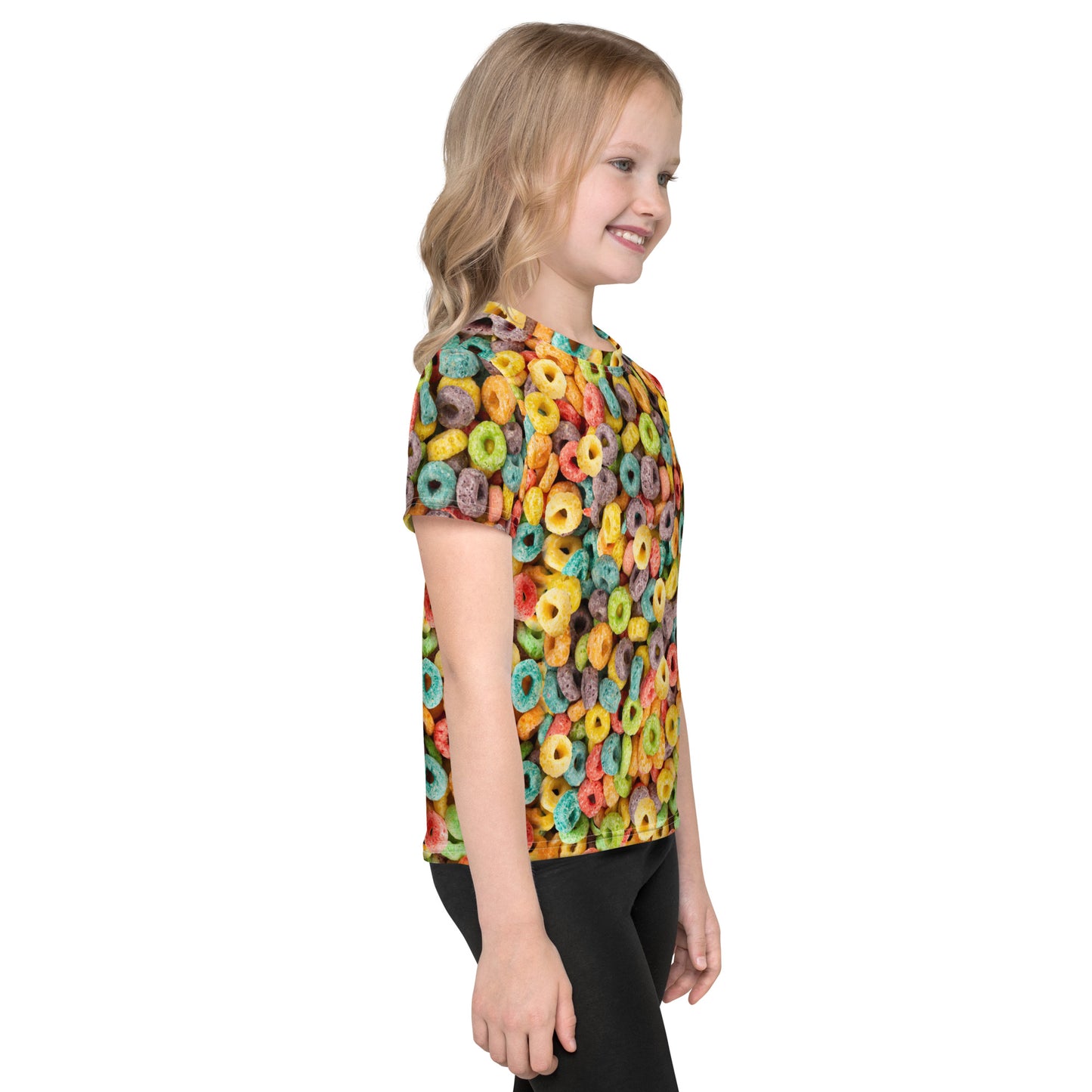 Little girl wearing an all over print Fruit Cereal Loops T-shirt, right side view