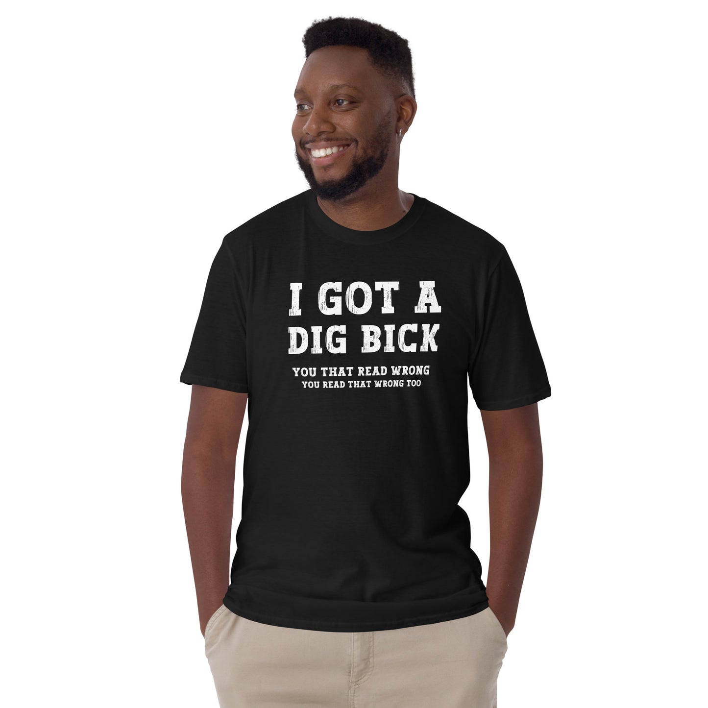 Amused young man wearing a black I got a Dig Bick Optical Illusion T-shirt that reads 'I got a Dig Bick, You That Read Wrong, You read that wrong too'.