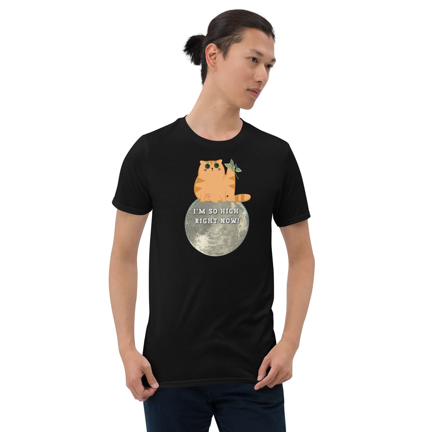 Young man wearing a black funny T-shirt featuring a ginger cat sat on the moon with wide eyes with catnip that reads 'I'm so high right now!'