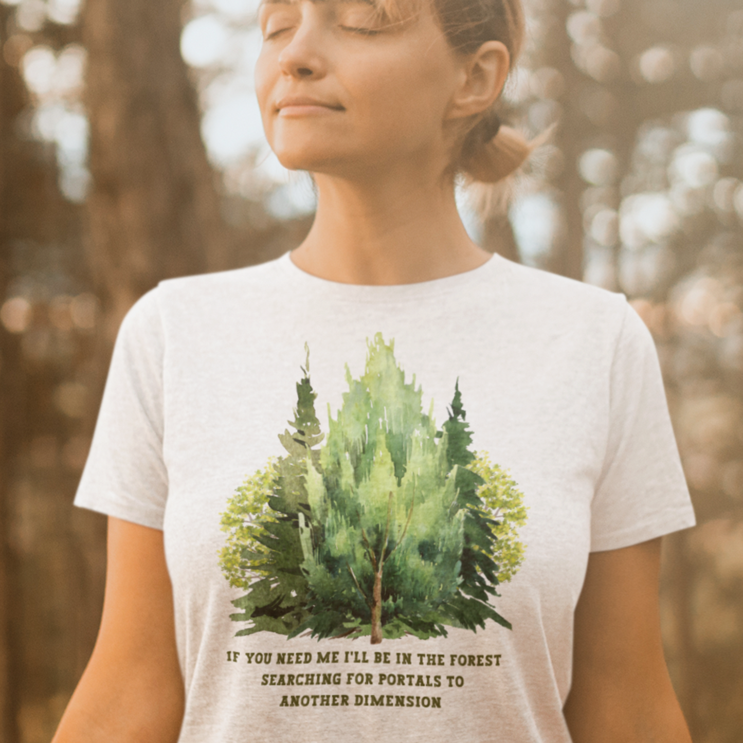 young woman meditating in a forest wearing a white If you need me i'll be in the forest searching for portals to another dimension, woodland graphic T-shirt