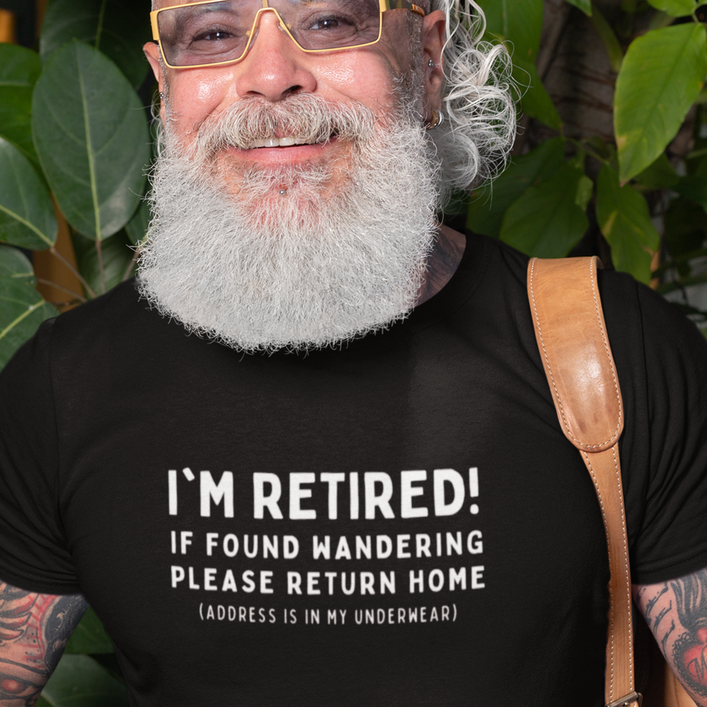 old man wearing a Funny retirement T-shirt that reads 'I'm retired - If found wandering please return home - address is in my underwear'. Black T-shirt, white text.