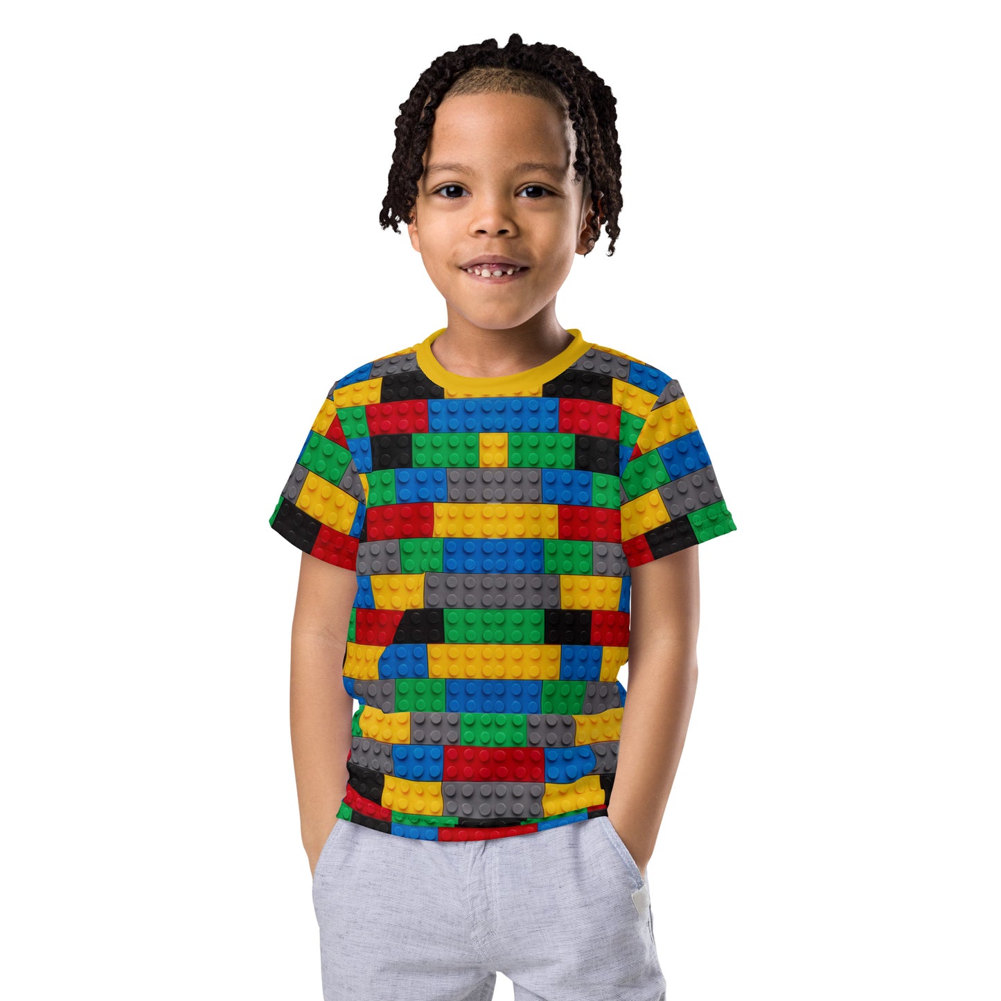 Little boy wearing a colourful building blocks all over print kid's T-shirt, front view