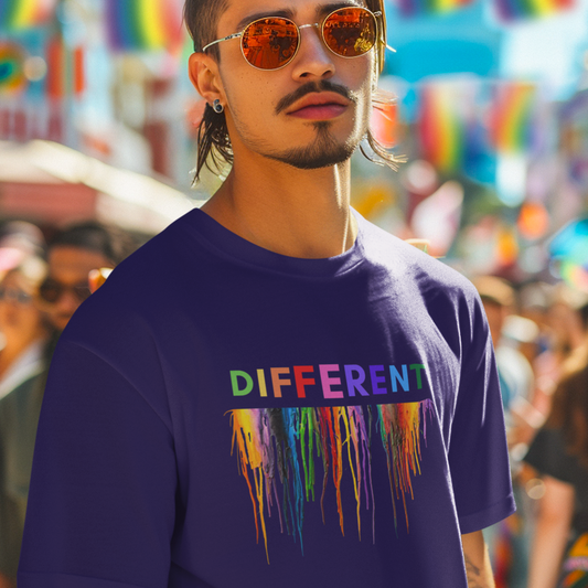 Man at a gay pride festival wearing a navy tee shirt with a melting wax crayons print that reads Different