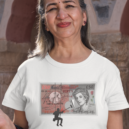 Hindu lady wearing a white T-shirt featuring a spoof £50 note with Princess Diana on it, the money is being posted to a wall by a silhouetted man.