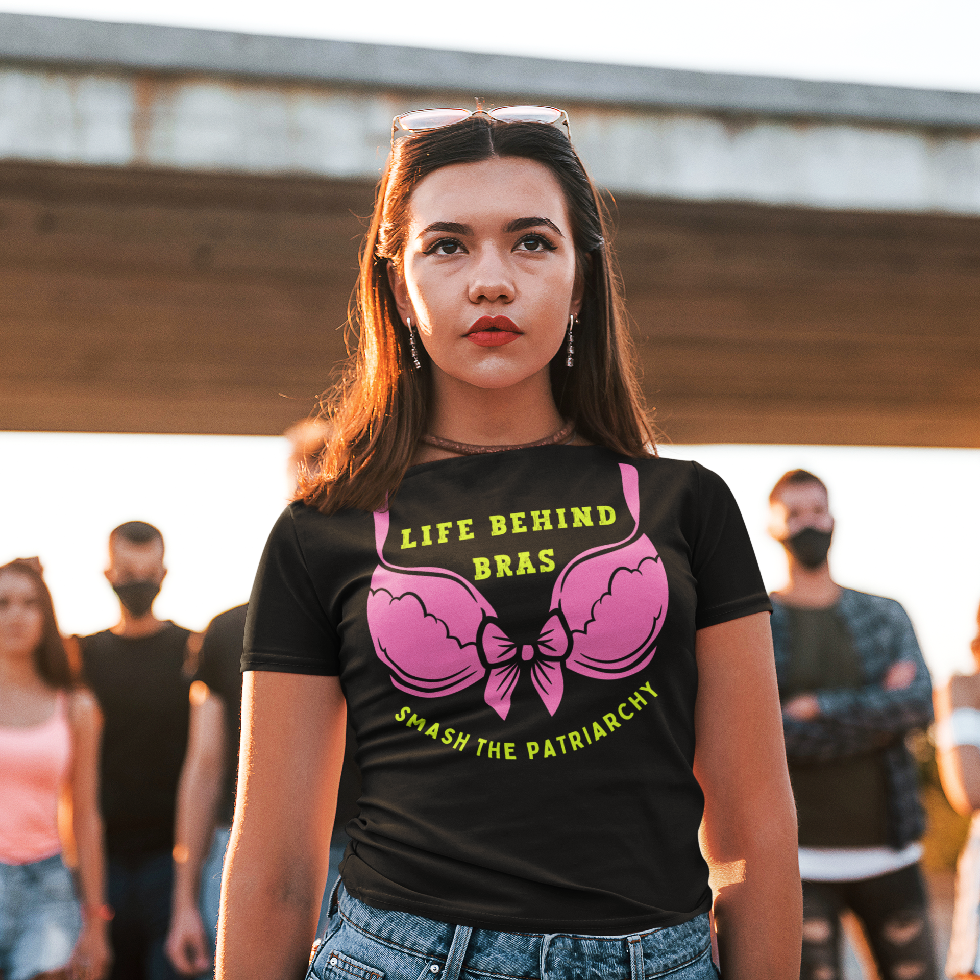 young woman wearing a black Feminism T-shirt Life Behind Bras, Smash the  Patriarchy.