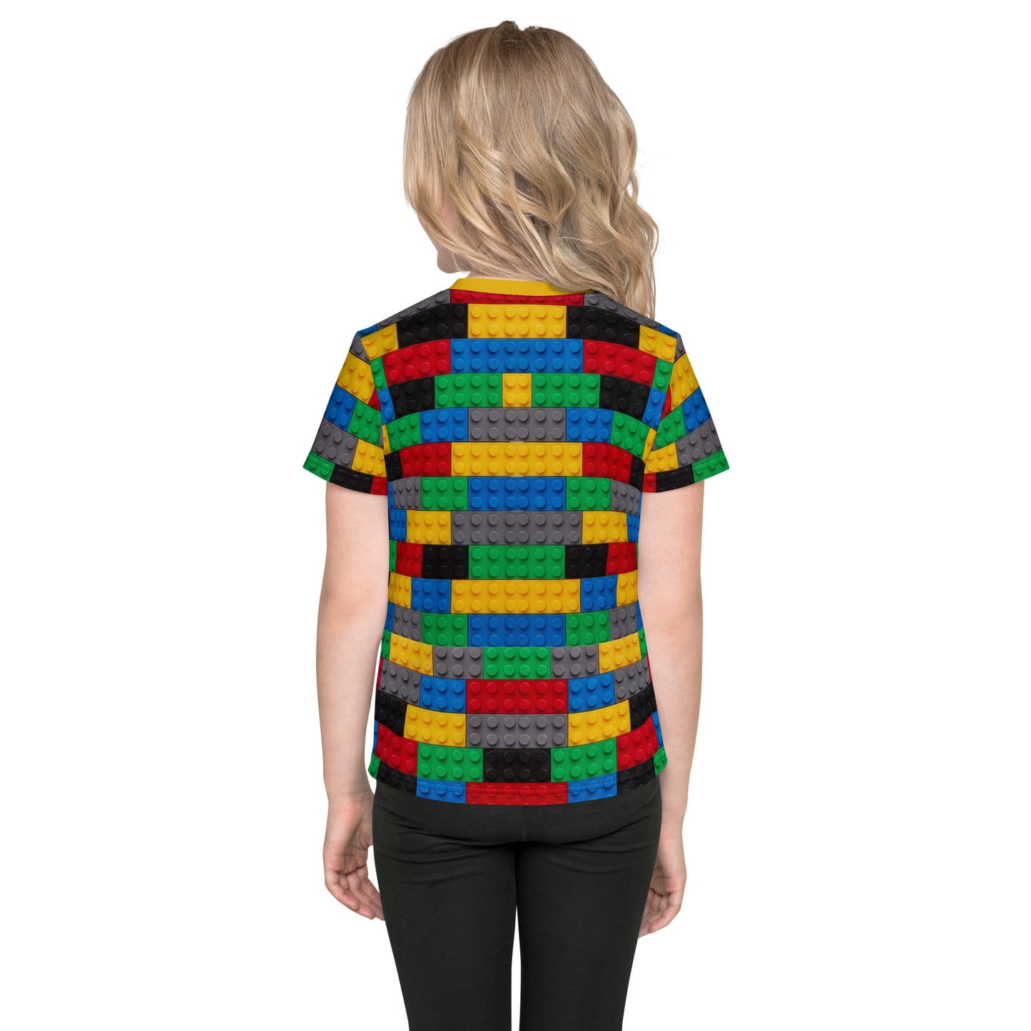 Little girl wearing a colourful building blocks all over print kid's T-shirt, back view