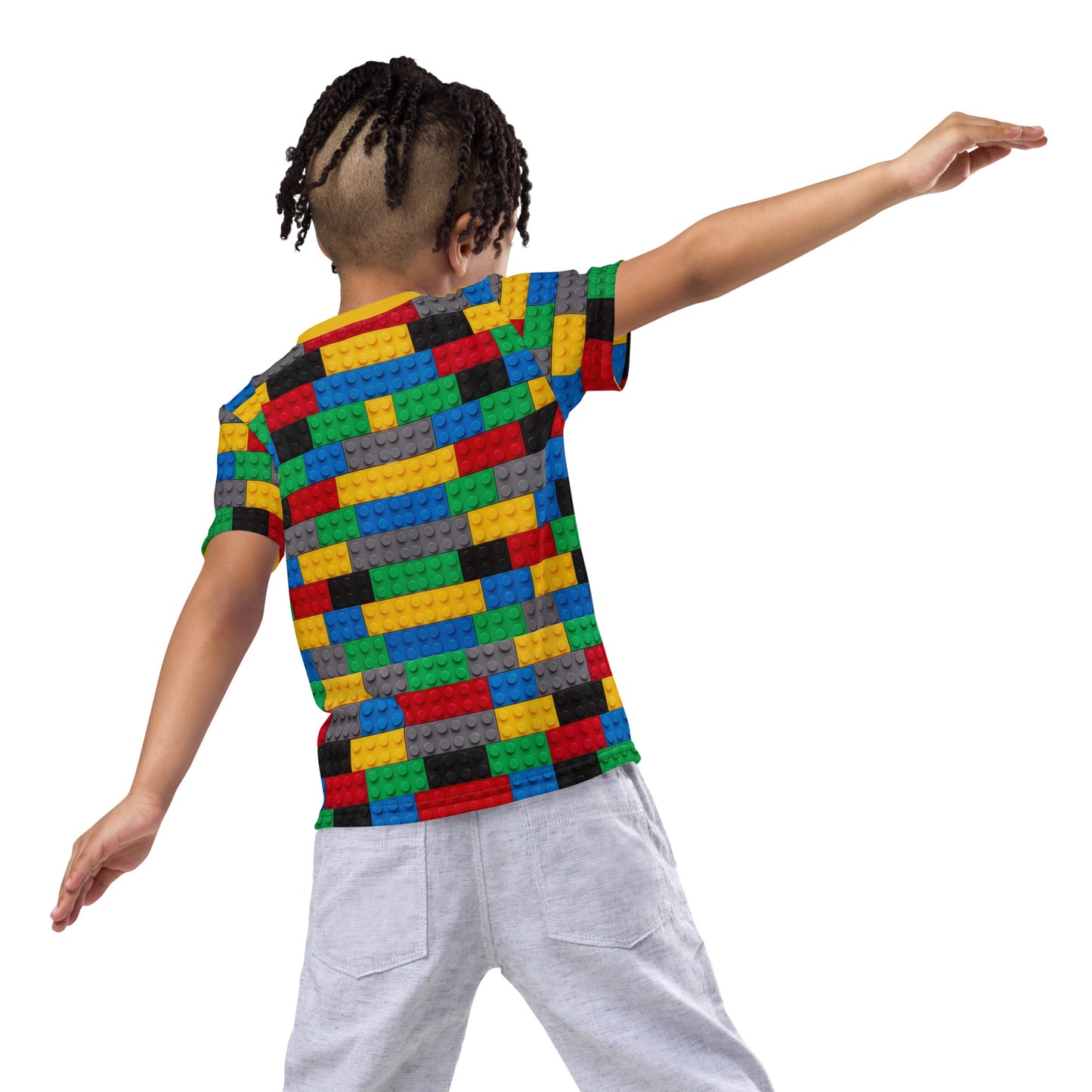 Little boy wearing a colourful building blocks all over print kid's T-shirt, rear view, boy pretending to be a plane