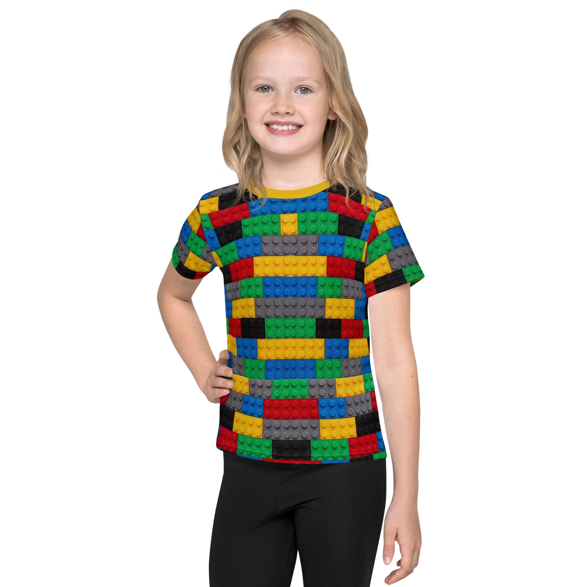 Little girl wearing a colourful building blocks all over print kid's T-shirt, front view