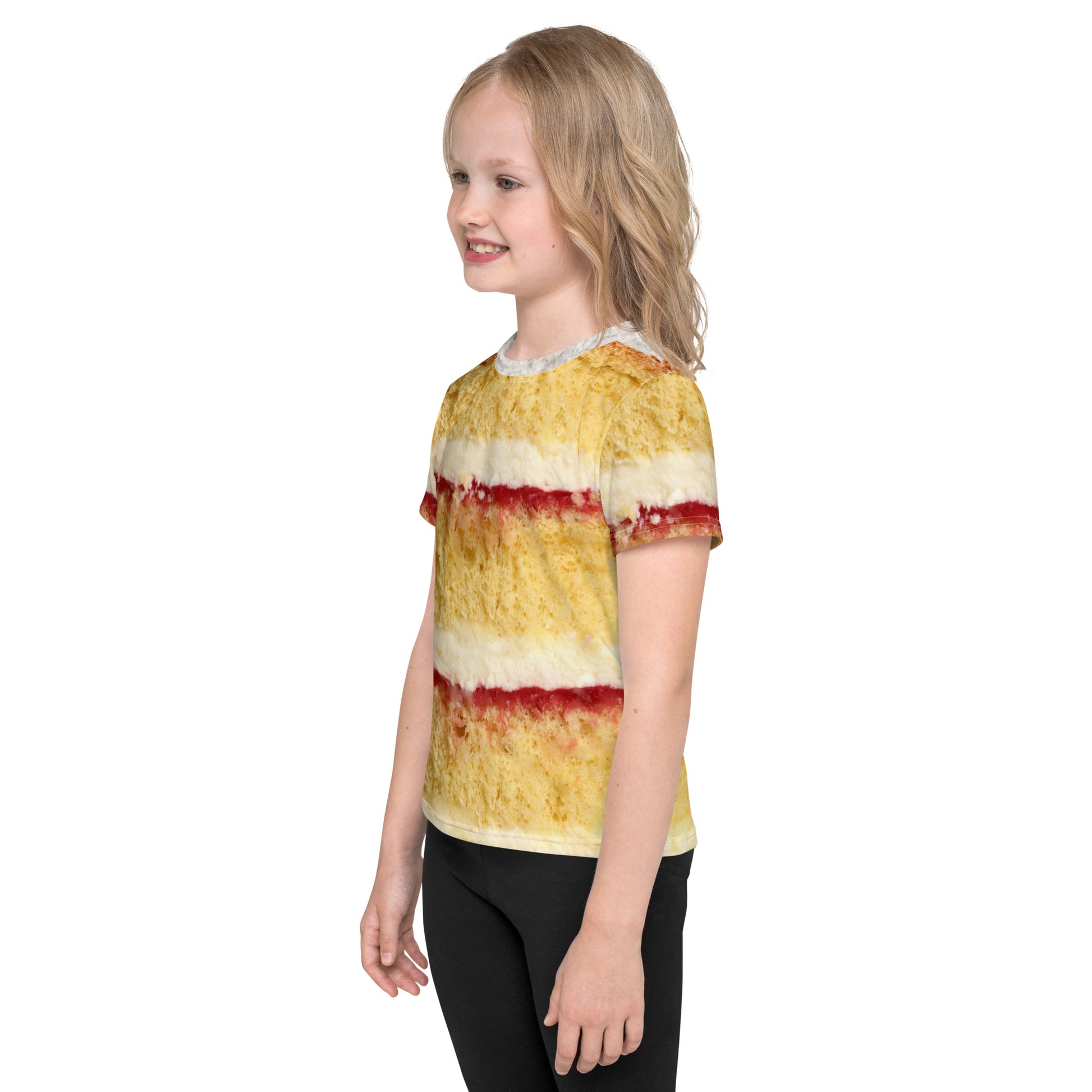 Little girl wearing Victoria sponge cake layers with fresh cream and jam all over print kid's T-shirt left view