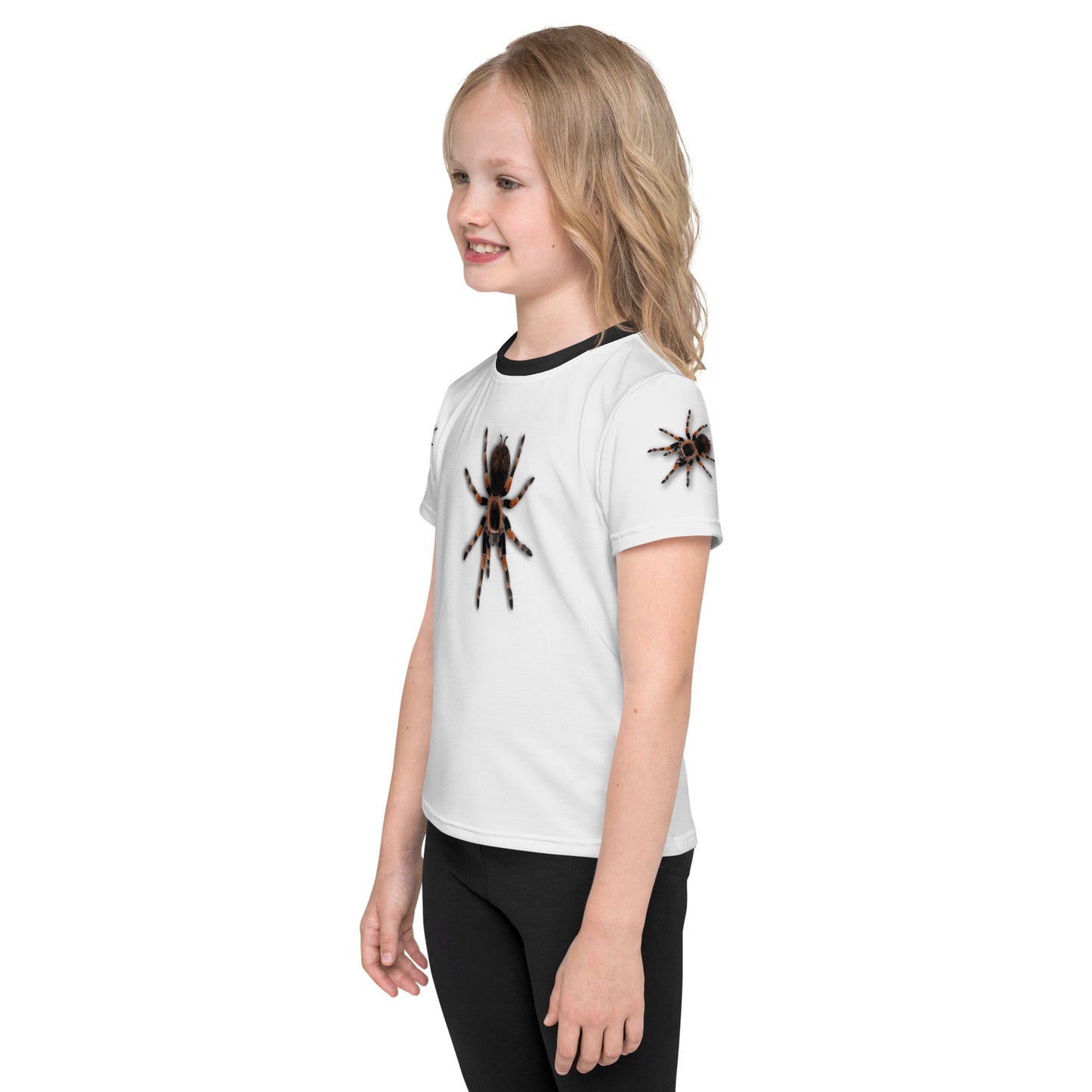 Little girl wearing a 3D Tarantula spider T-shirt with one spider on each arm, front and back of shirt. Front left view.