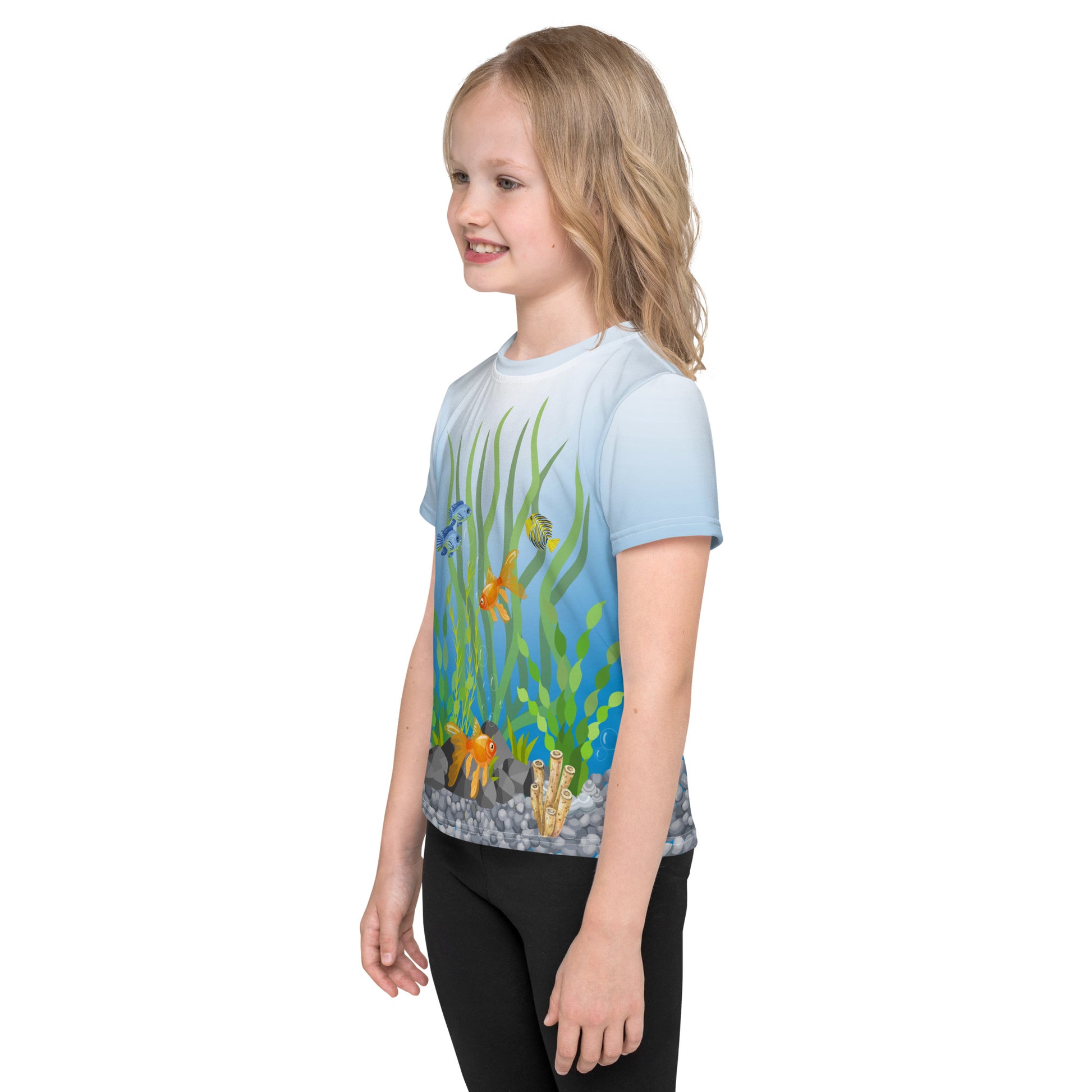 Little girl wearing a tropical fish aquarium scene all over print T-shirt, left side view