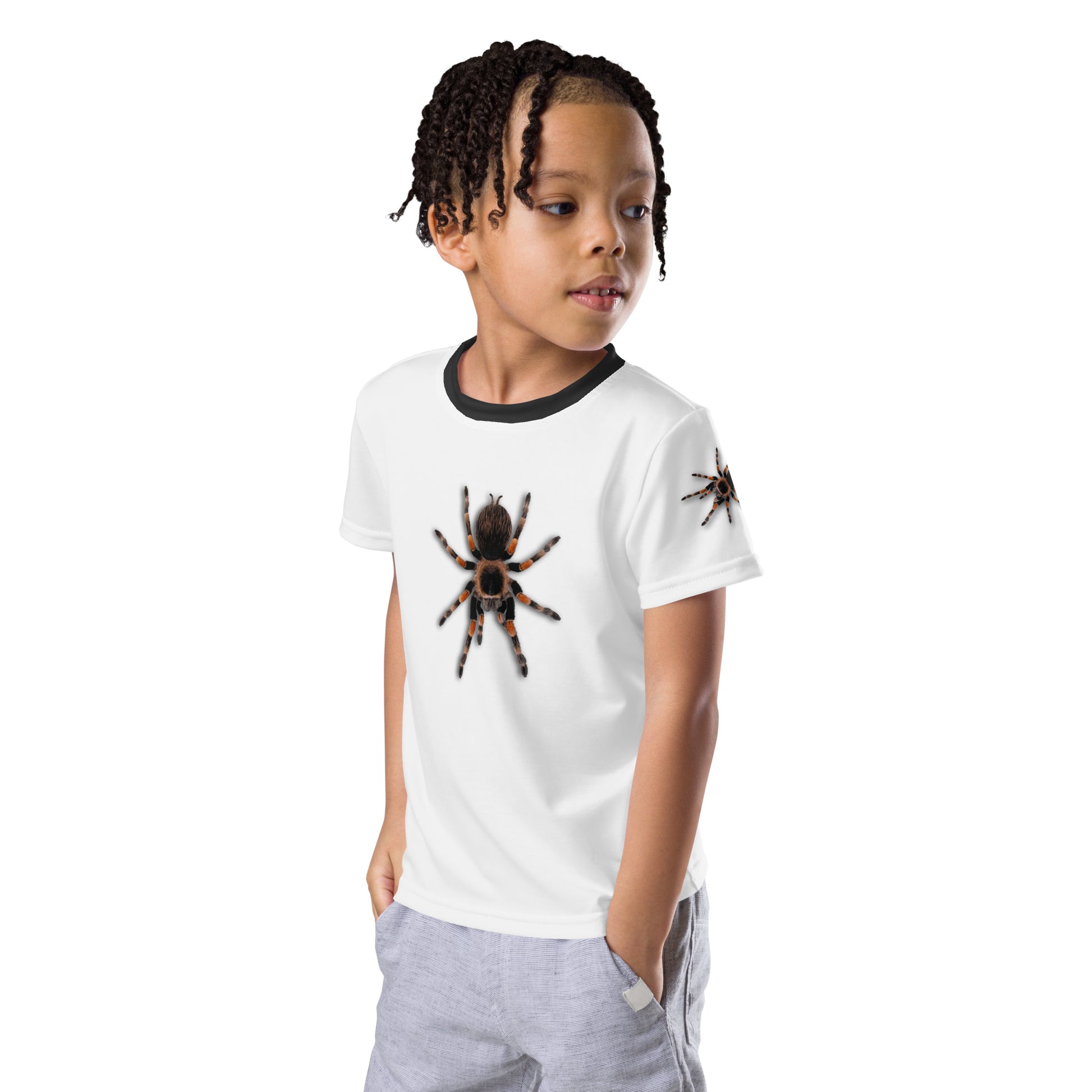 Little boy wearing a 3D Tarantula spider T-shirt with one spider on each arm, front and back of shirt. Front left view.