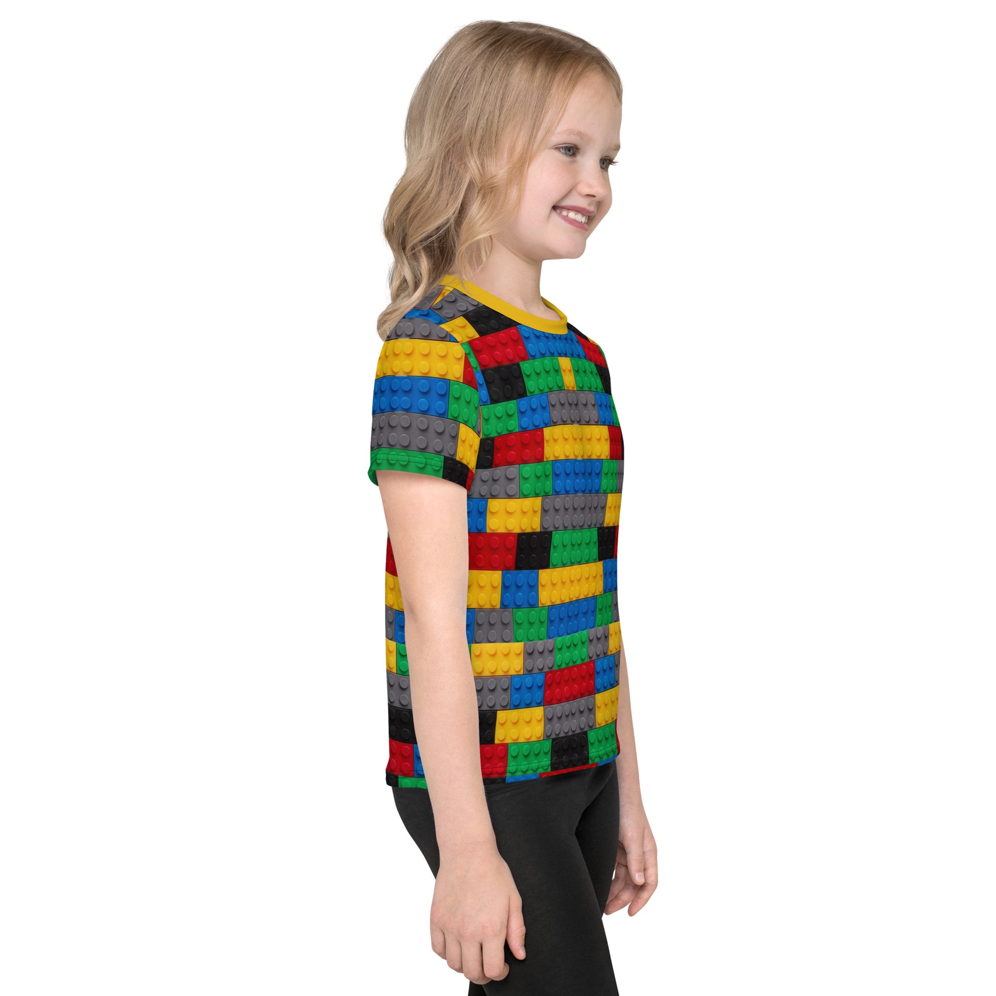 Little girl wearing a colourful building blocks all over print kid's T-shirt, right side view