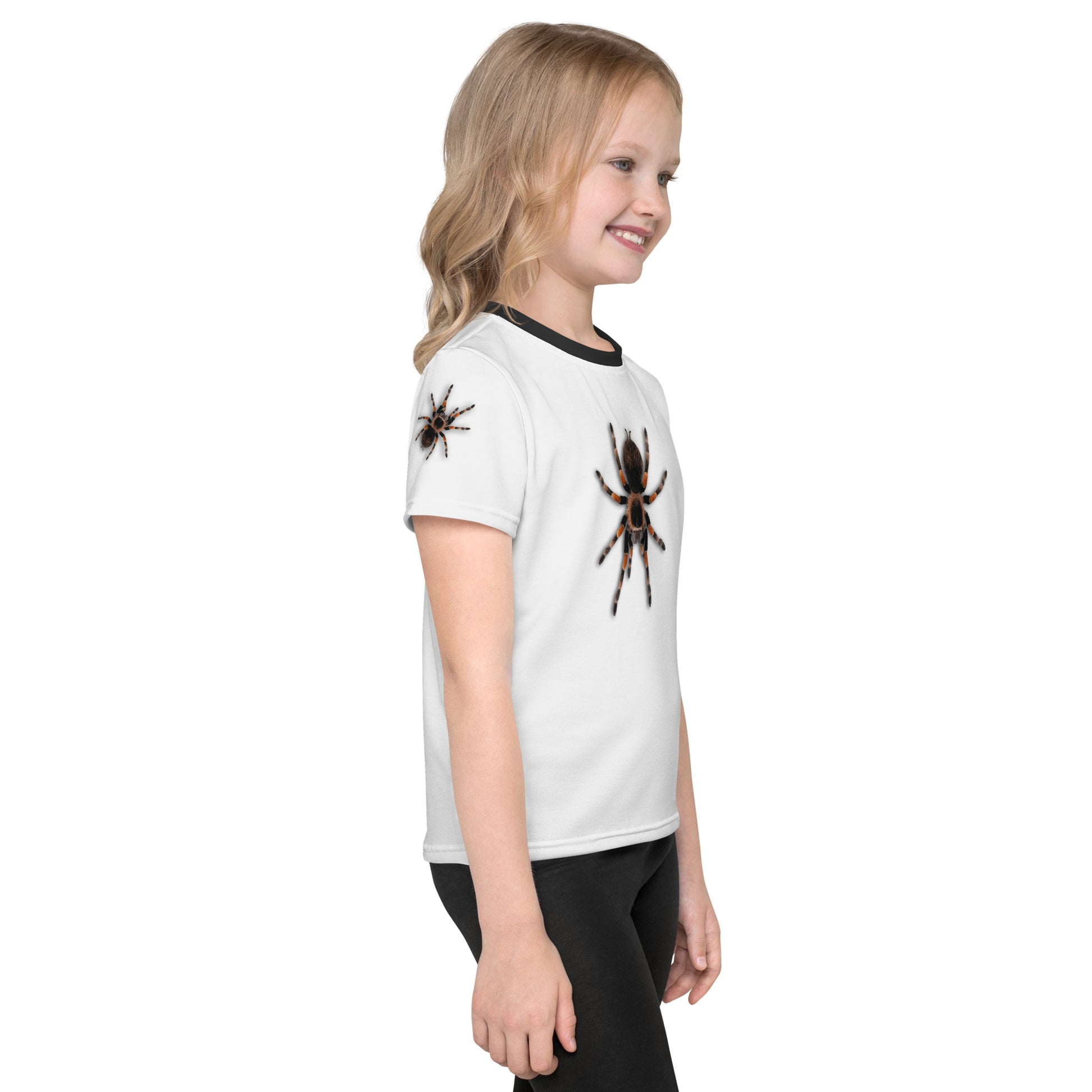 Little girl wearing a 3D Tarantula spider T-shirt with one spider on each arm, front and back of shirt. Front right view.