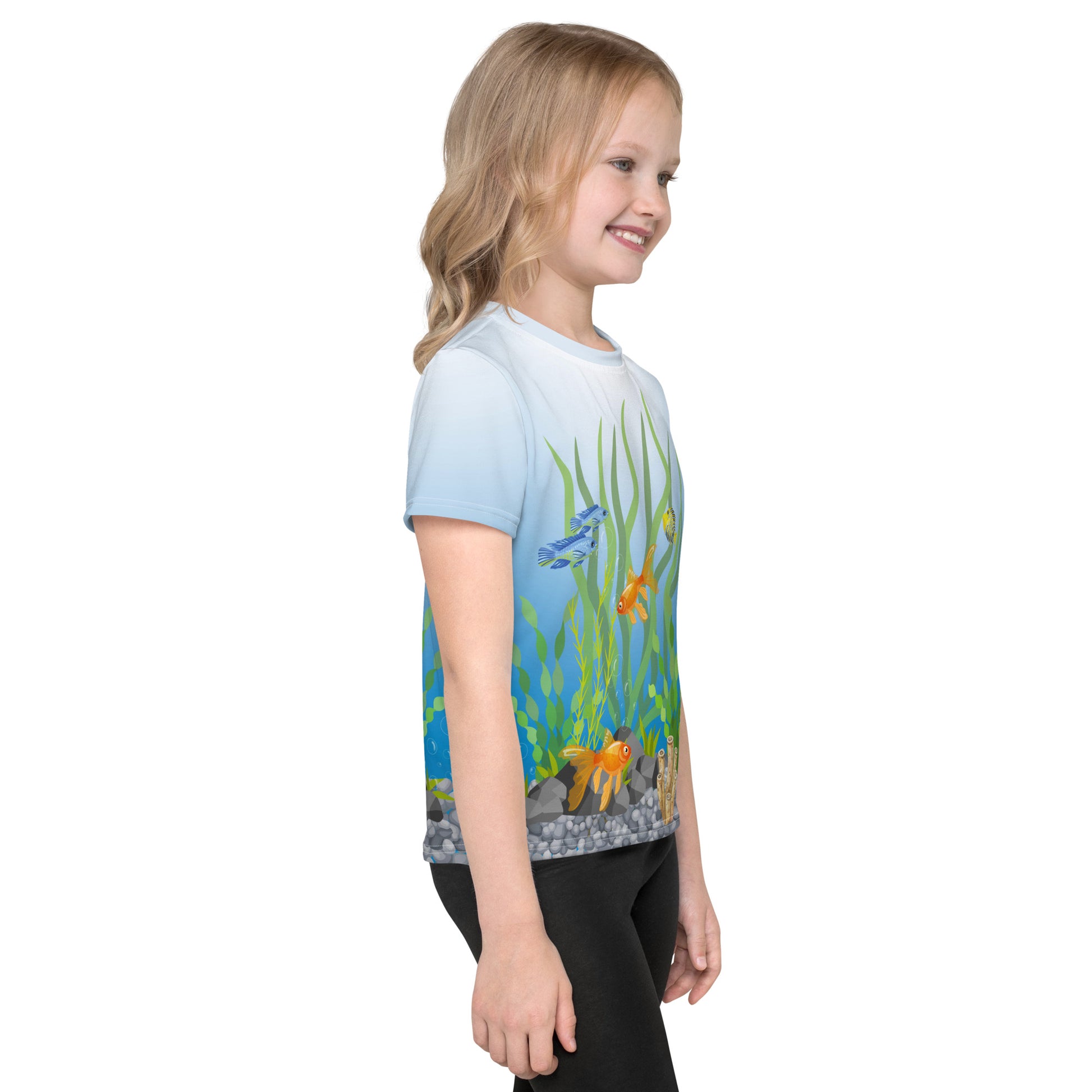 Little girl wearing a tropical fish aquarium scene all over print T-shirt, right side view