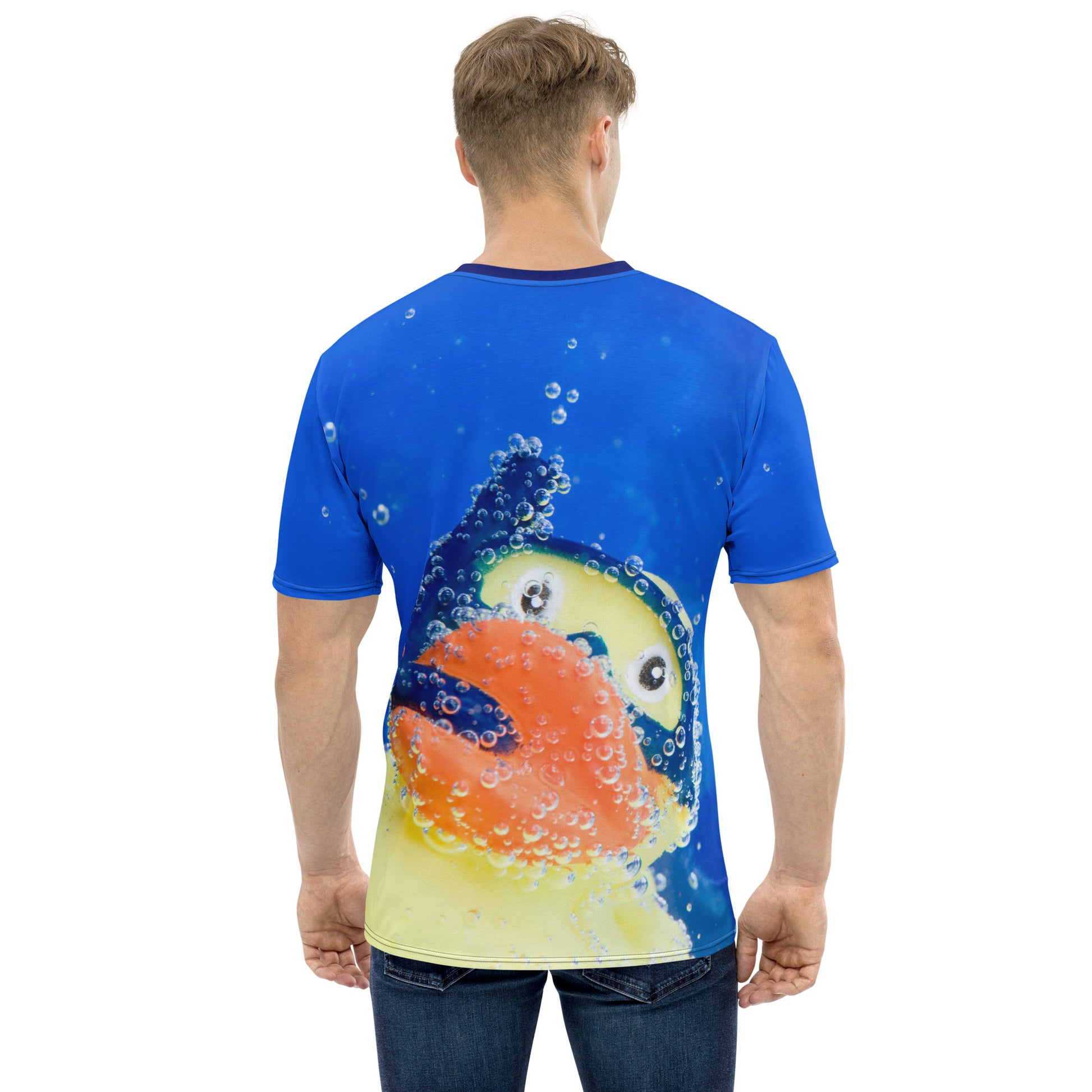 Young man wearing an All over print Rubber Duck Snorkelling Underwater T-shirt, rear view.