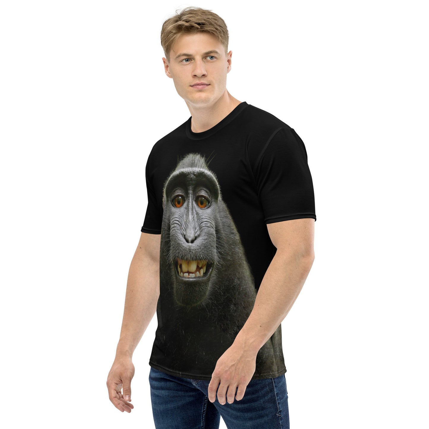 Young man modelling a Funny monkey face all over print men's T-shirt, left side.