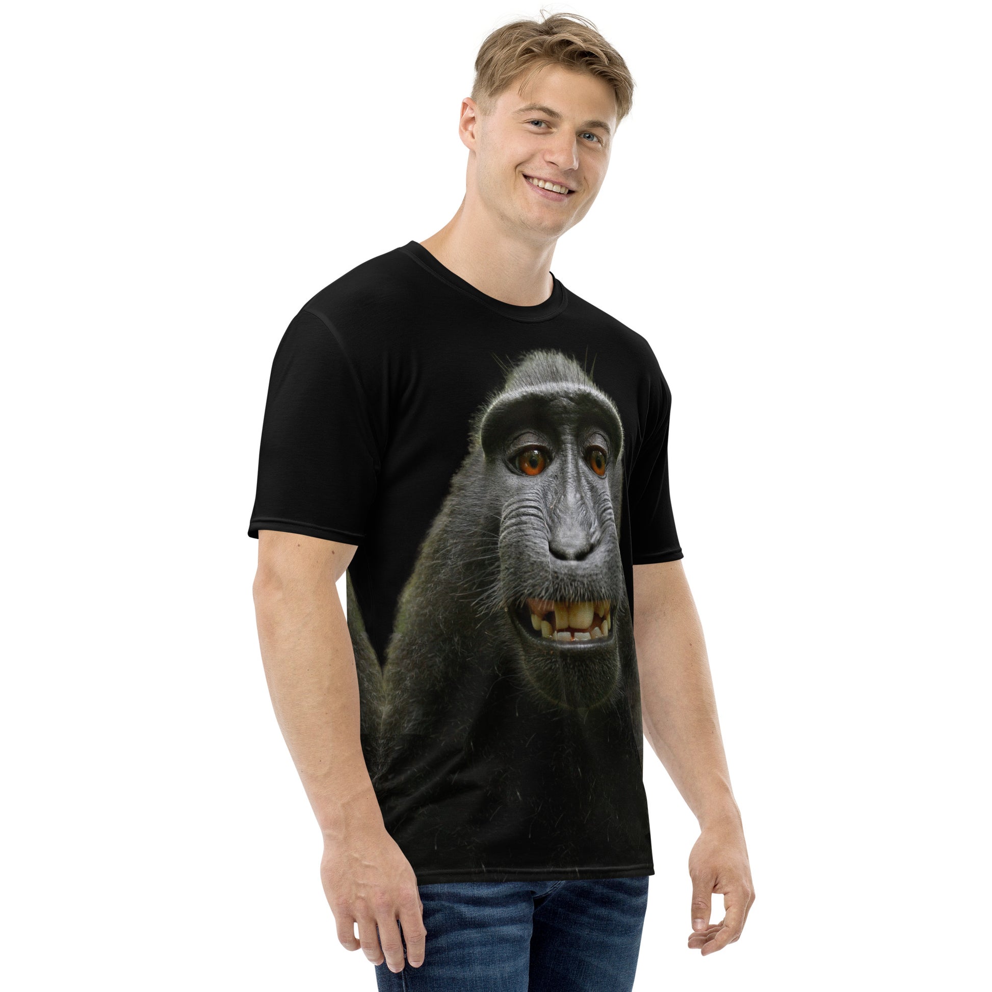 Young man modelling a Funny monkey face all over print men's T-shirt, right side.