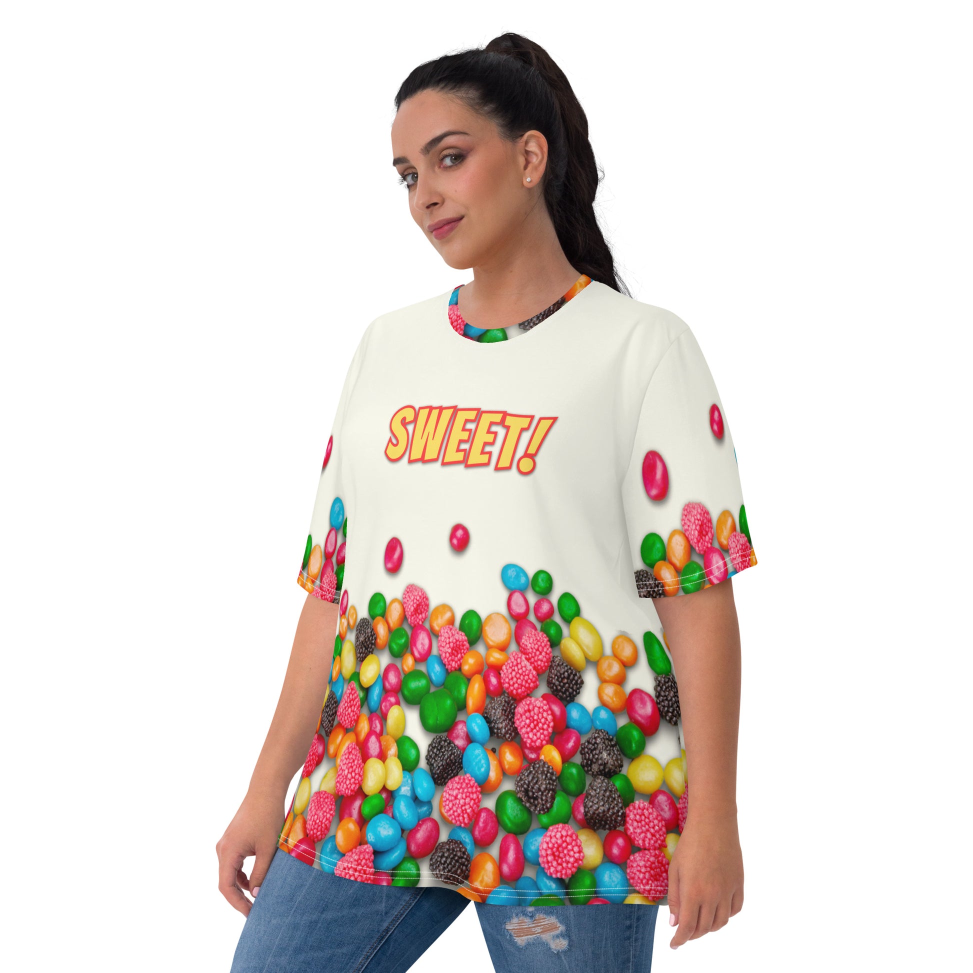 Plus size young woman wearing an all over print colourful Candy print T-shirt with SWEET!  on the front, front view.