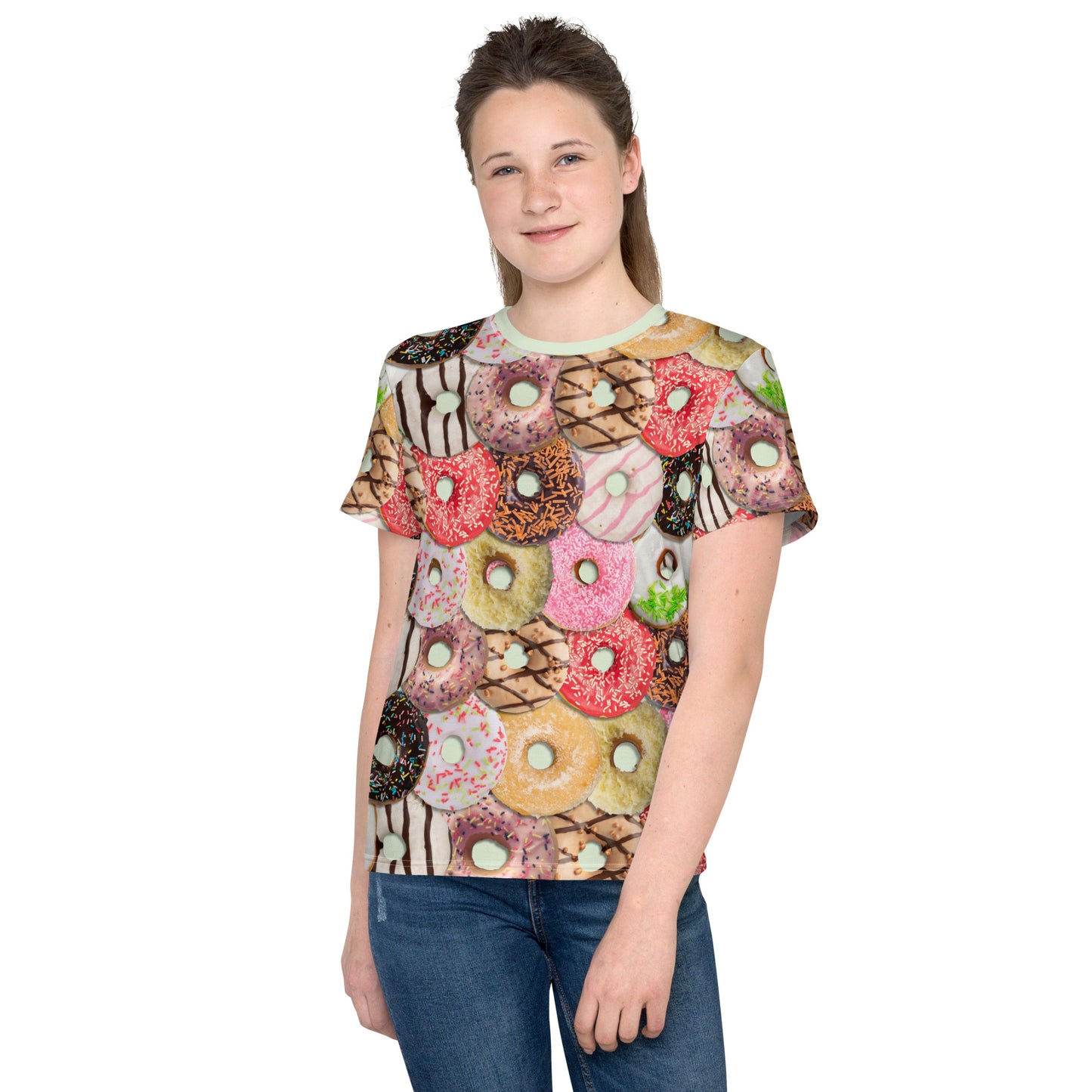 Teenage girl wearing a colourful iced doughnuts all over print T-shirt, front view.