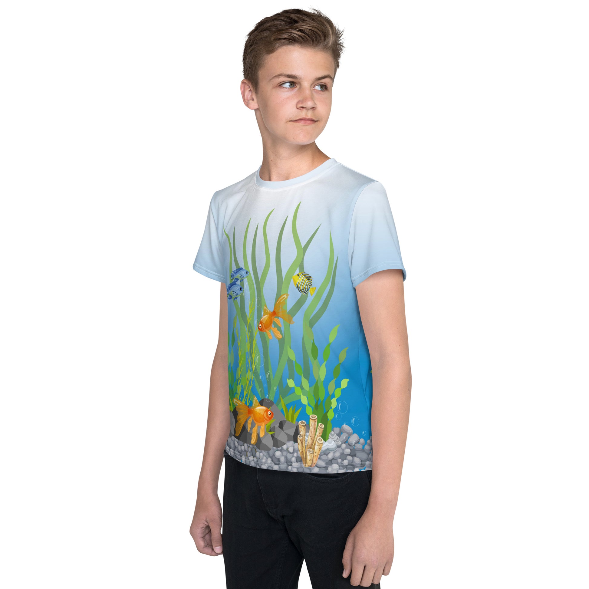 Teenage boy wearing an all over print tropical fish aquarium scene T-shirt, left front view.