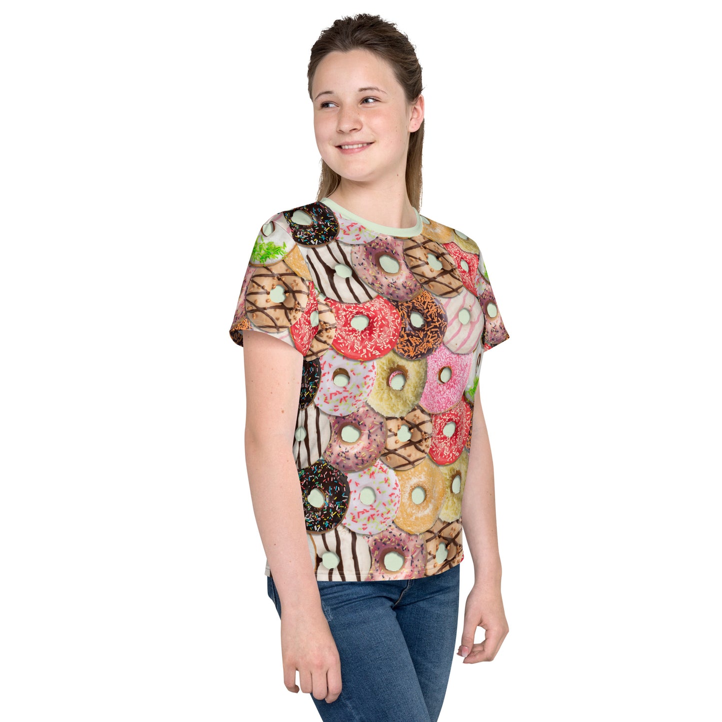 Teenage girl wearing a colourful iced doughnuts all over print T-shirt, front right view.