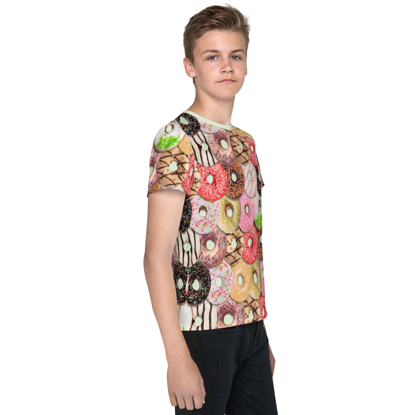 Teenage boy wearing a colourful iced doughnuts all over print T-shirt, right side.