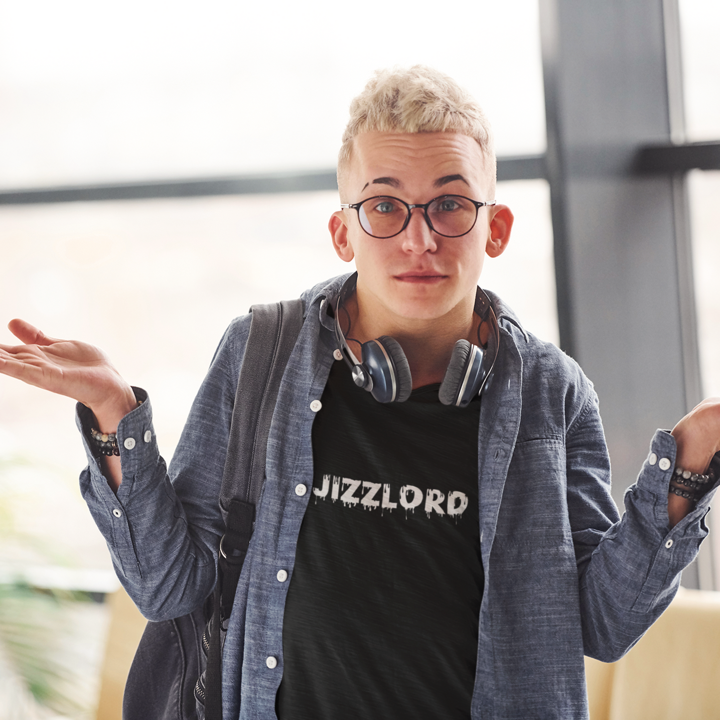 Male college student wearing a black offensive t-shirt that reads Jizzlord