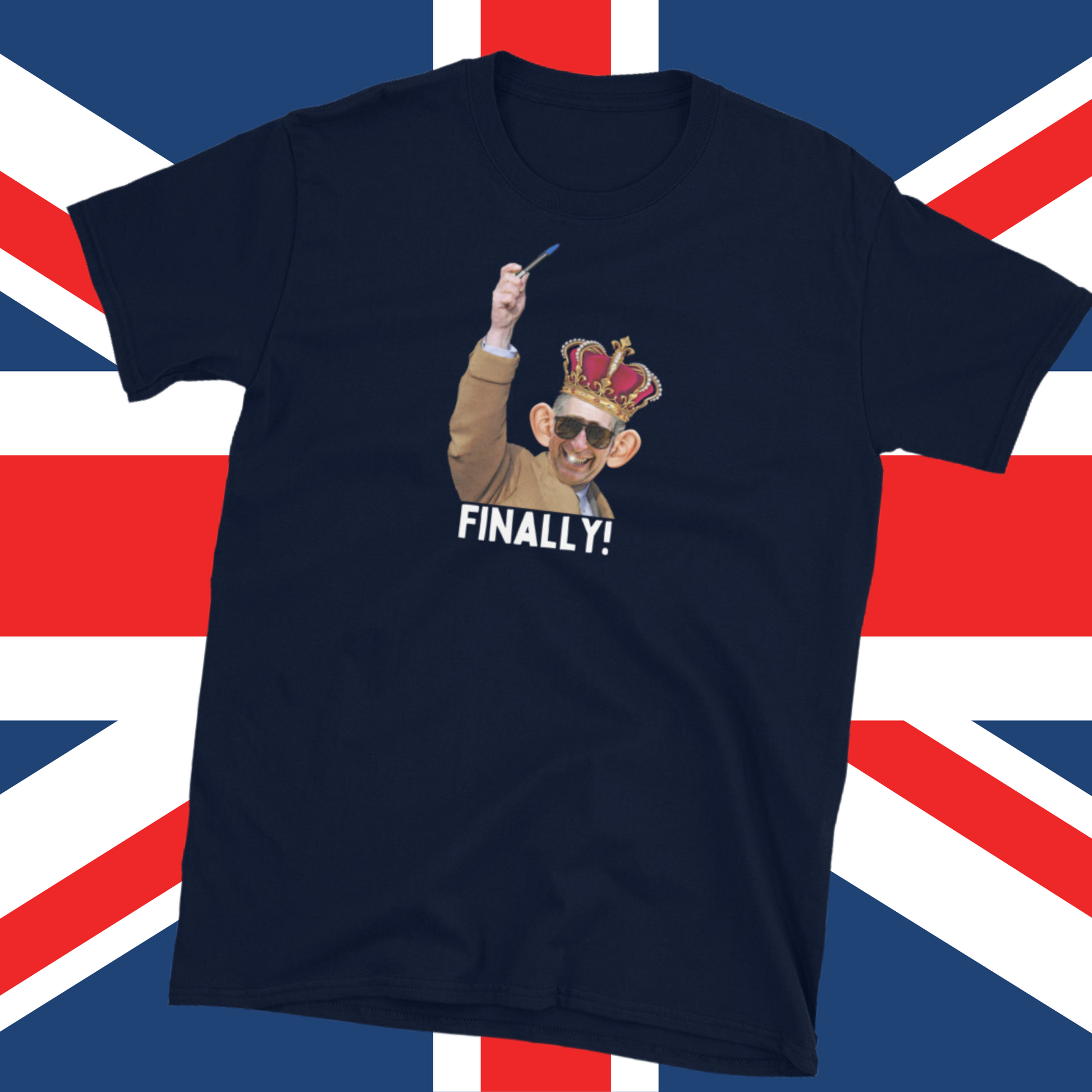 Navy blue funny King Charles coronation T-shirt with Charles holding up a biro instead of a leaky ink pen, wearing a wonky crown laying flat on a British flag.