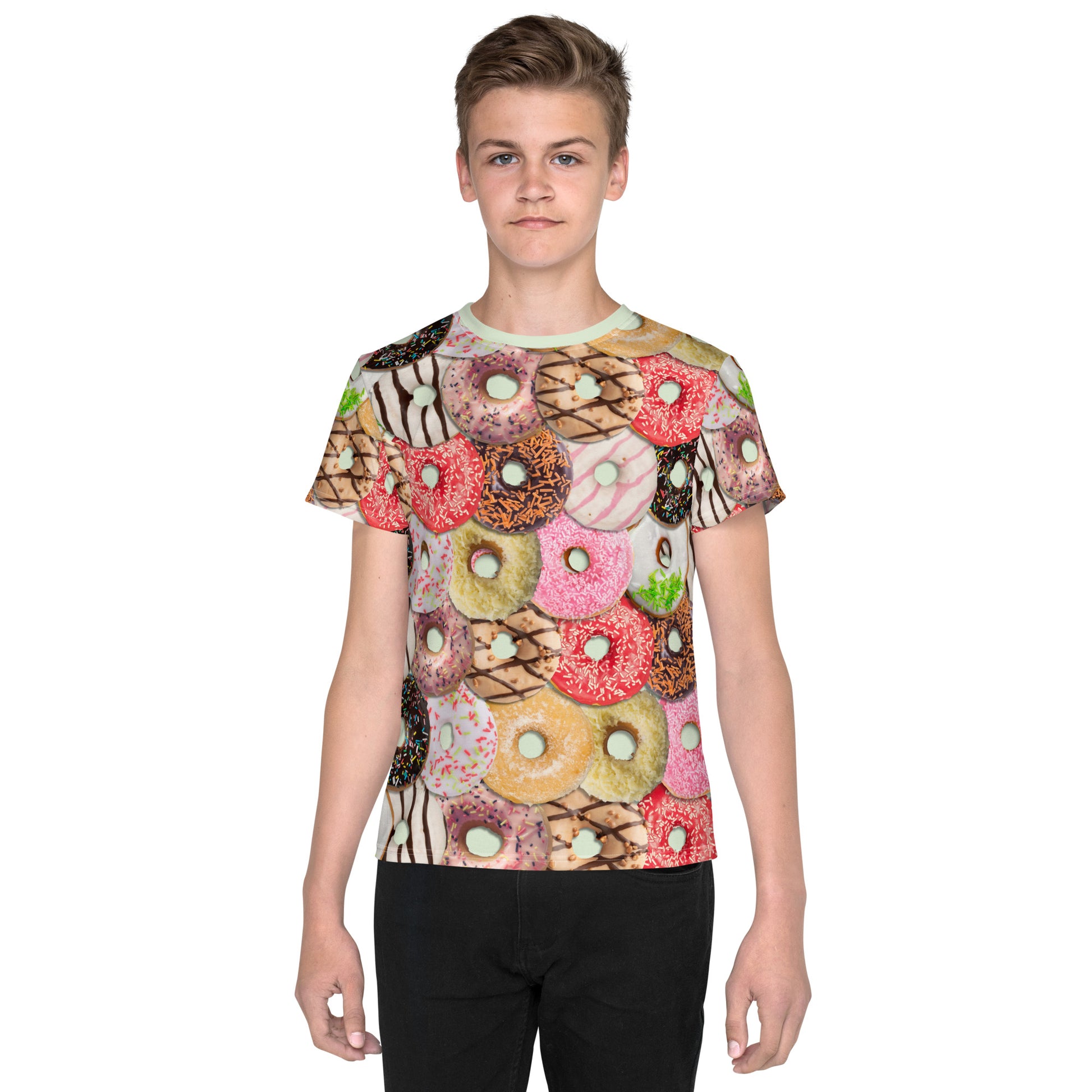 Teenage boy wearing a colourful iced doughnuts all over print T-shirt, facing forwards.