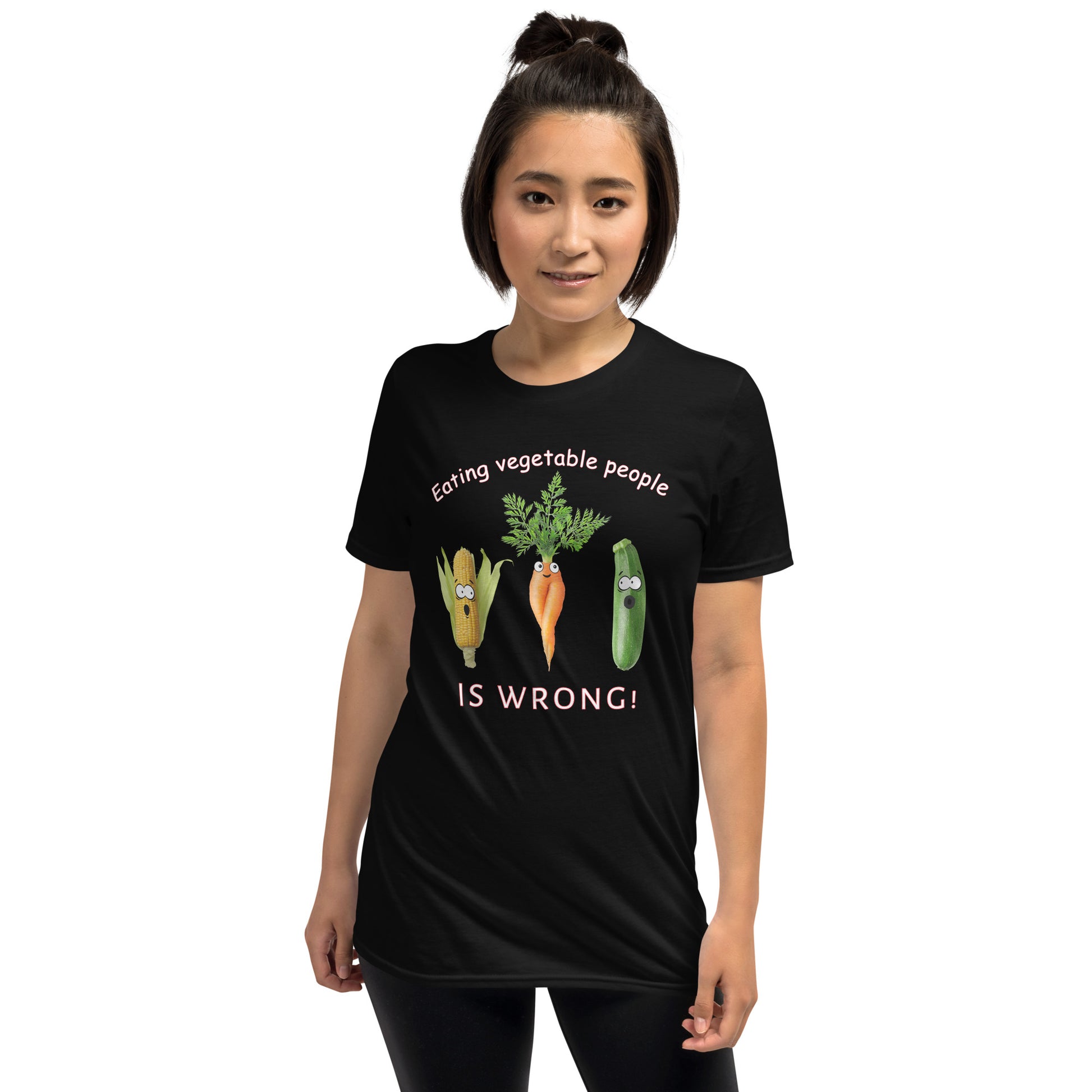 young woman wearing a black Eating Vegetable People is Wrong! T-shirt with humanised vegetables.