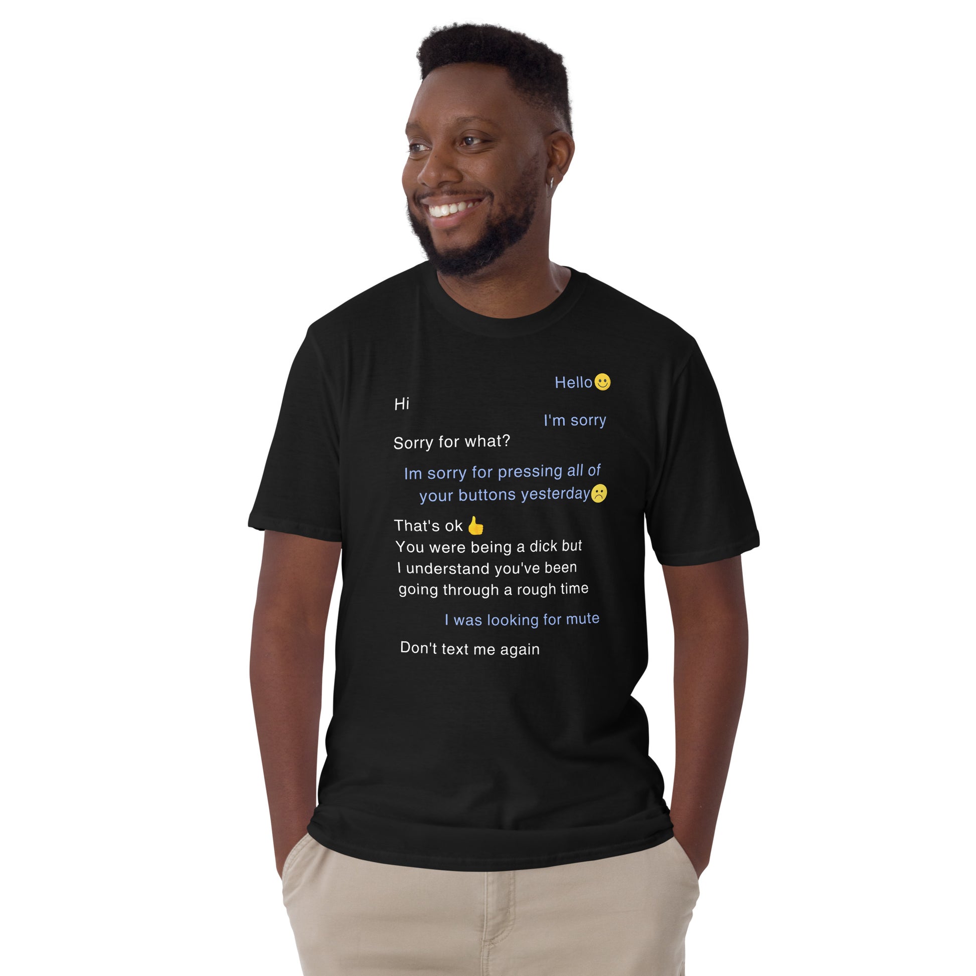 young man wearing a black funny t-shirt with sarcastic text in form of a text message that says Sorry for pressing all of your buttons yesterday, I was looking for mute.