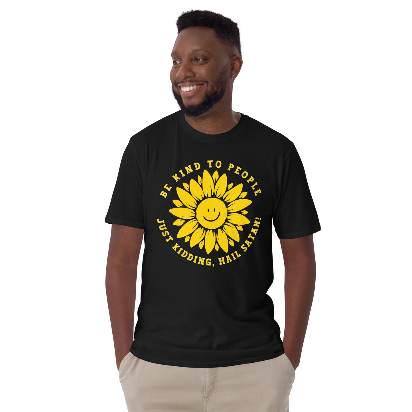 male model wearing a black Funny T-shirt with a smiling sunflower design and yellow text that reads, Be Kind To people, Just Kidding, Hail Satan!