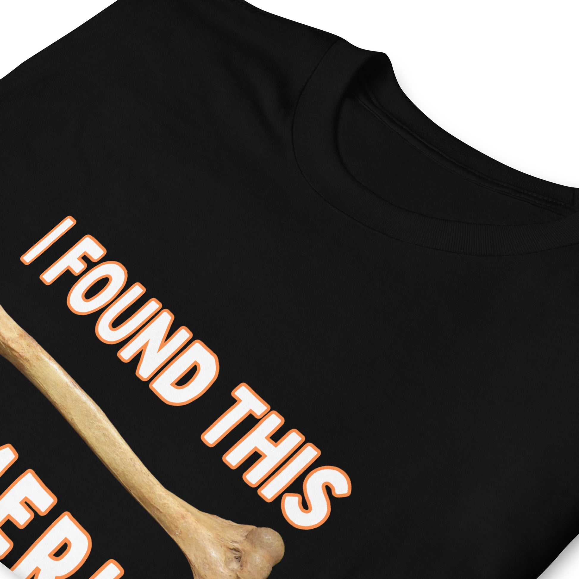 Black funny Funny T-shirt that has a arm bone on it and reads 'I found this humerus', folded with white letters