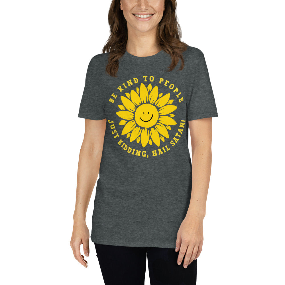 female model wearing a dark heather grey Funny T-shirt with a smiling sunflower design and yellow text that reads, Be Kind To people, Just Kidding, Hail Satan!