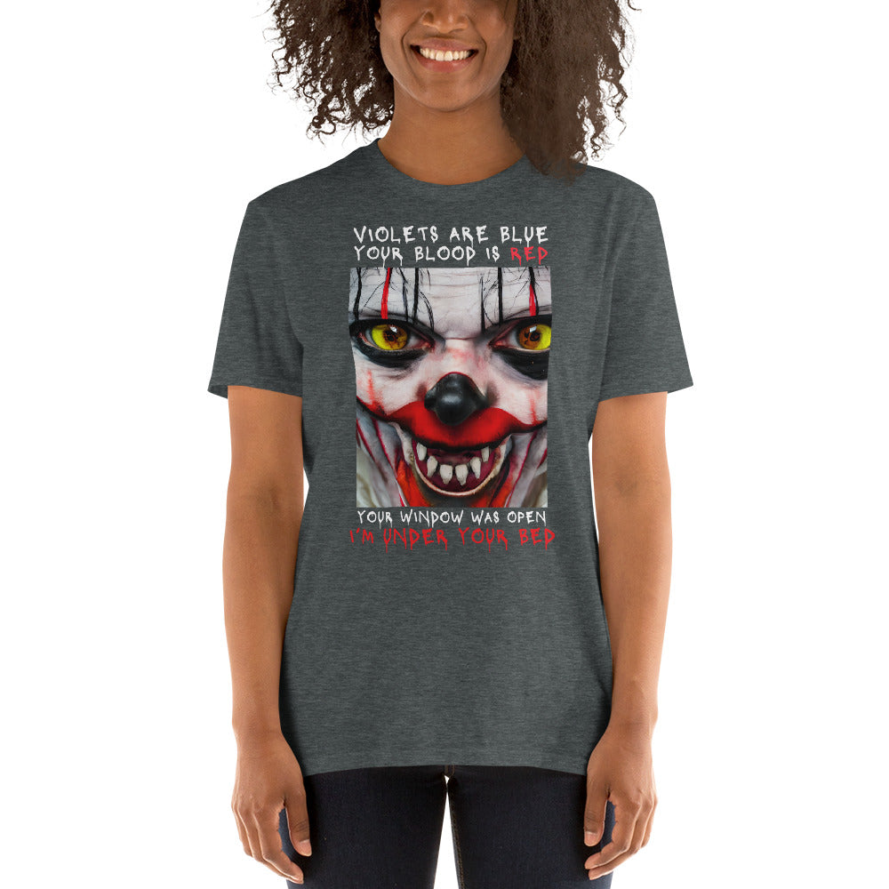 Model wearing a dark grey heather Scary Clown Halloween T shirt that shows a creepy clowns face with text that reads Violets are blue, your blood is red, your window was open, I'm under your bed