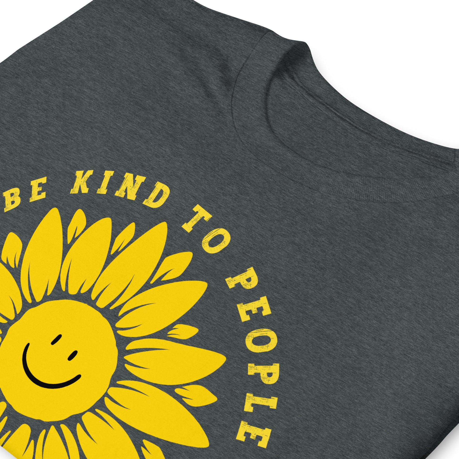 folded dark heather Funny T-shirt with a smiling sunflower design and yellow text that reads, Be Kind To people, Just Kidding, Hail Satan!