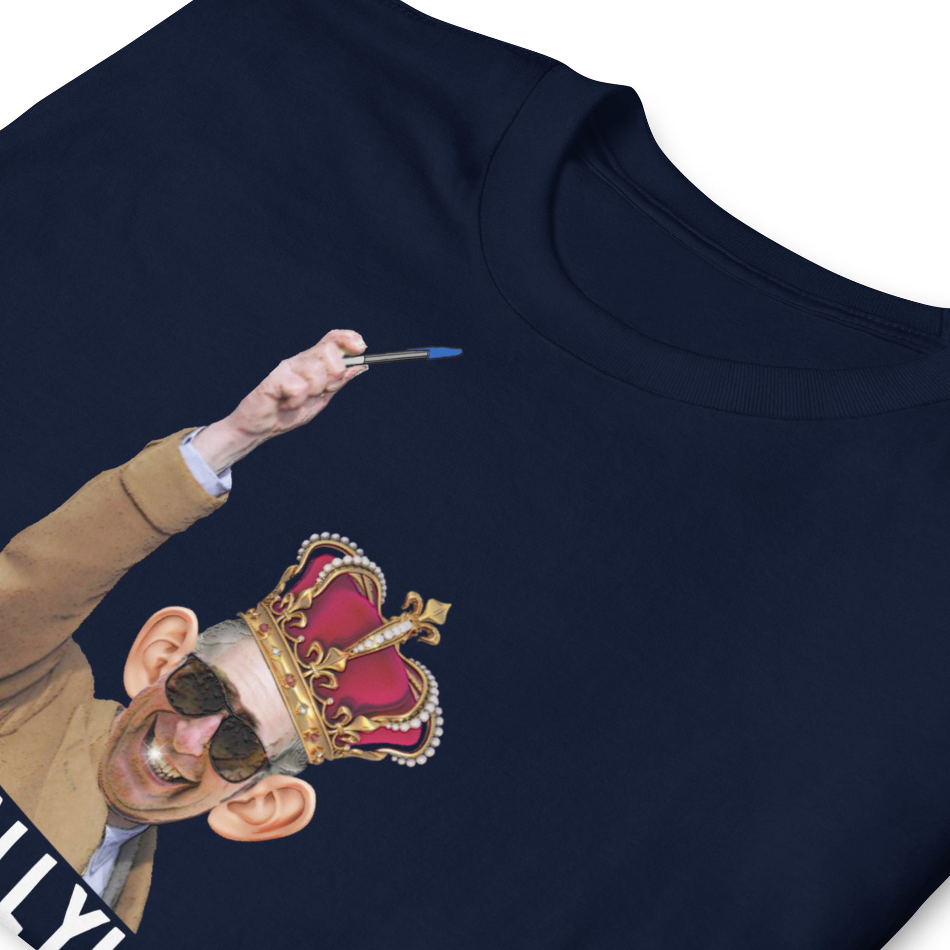 folded navy blue funny King Charles coronation T-shirt with Charles holding up a biro instead of a leaky ink pen, wearing a wonky crown.