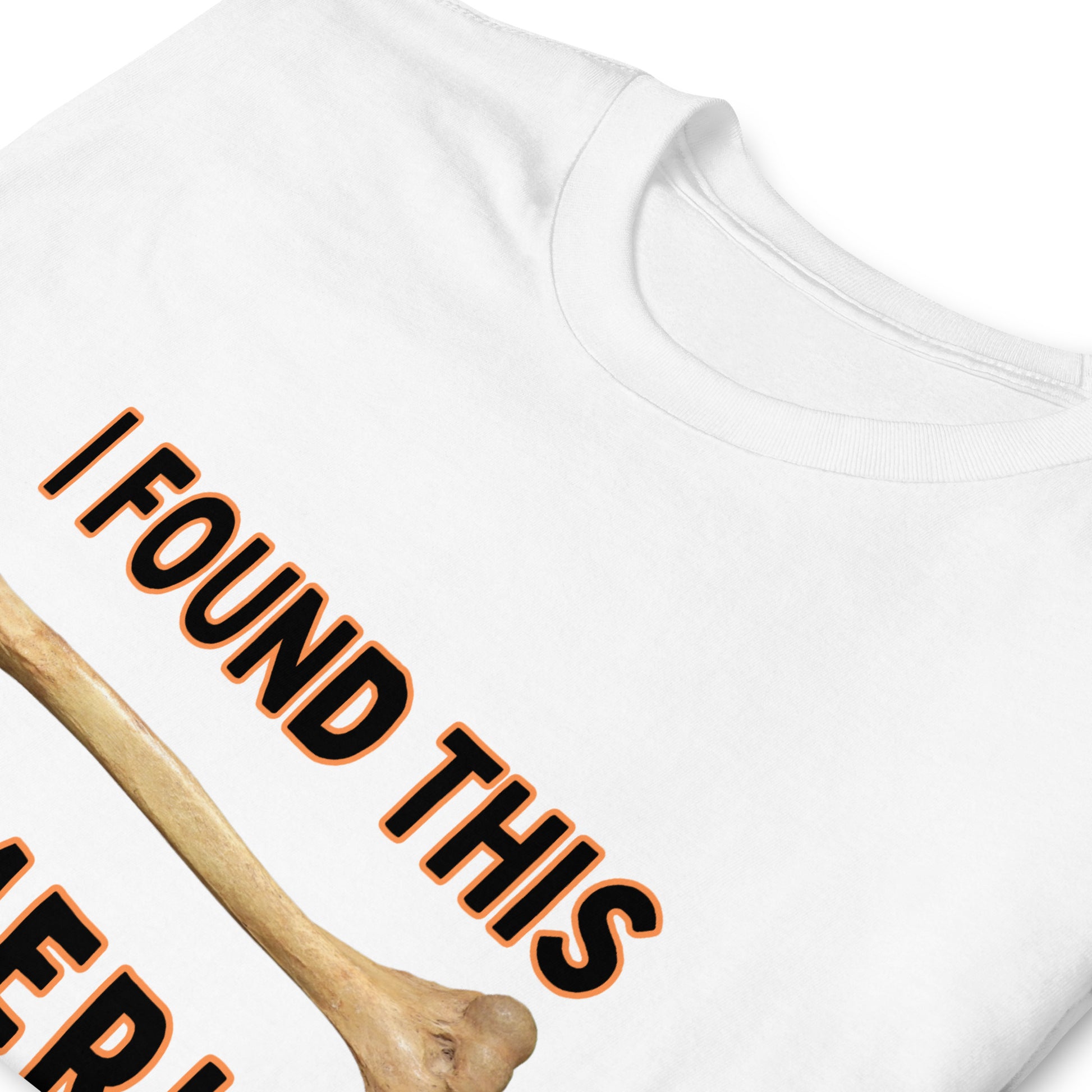 folded white Funny T-shirt that has a arm bone on it and reads 'I found this humerus'