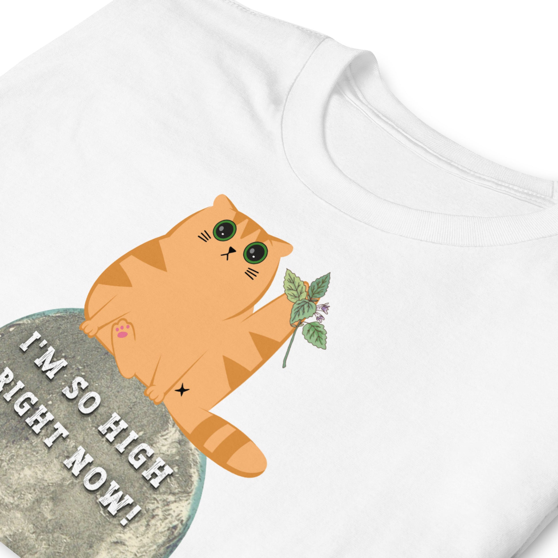 folded white funny T-shirt featuring a ginger cat sat  on the moon with wide eyes with catnip that reads 'I'm so high right now!'