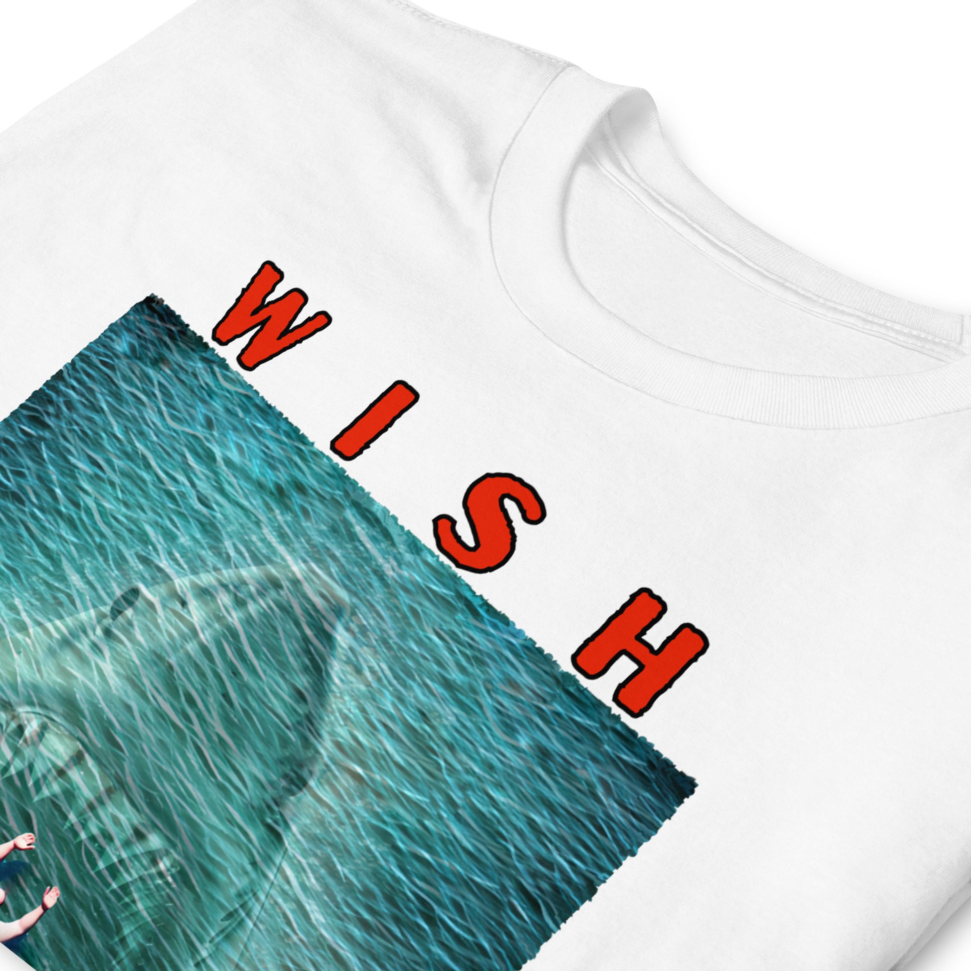 folded, white, funny T-shirt with an image of a fat guy floating in the sea, with a large shark with its jaws open coming up underneath him, text reads, Wish you were here